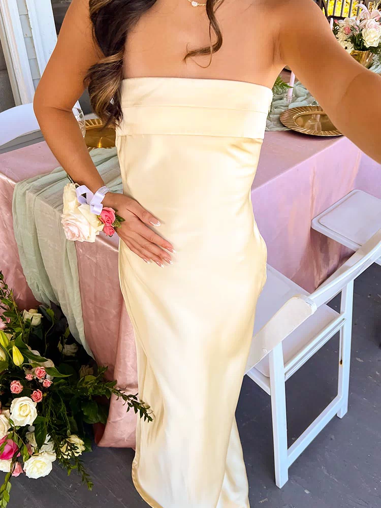 Close-up of the strapless neckline and fitted bodice of a pale yellow maxi dress