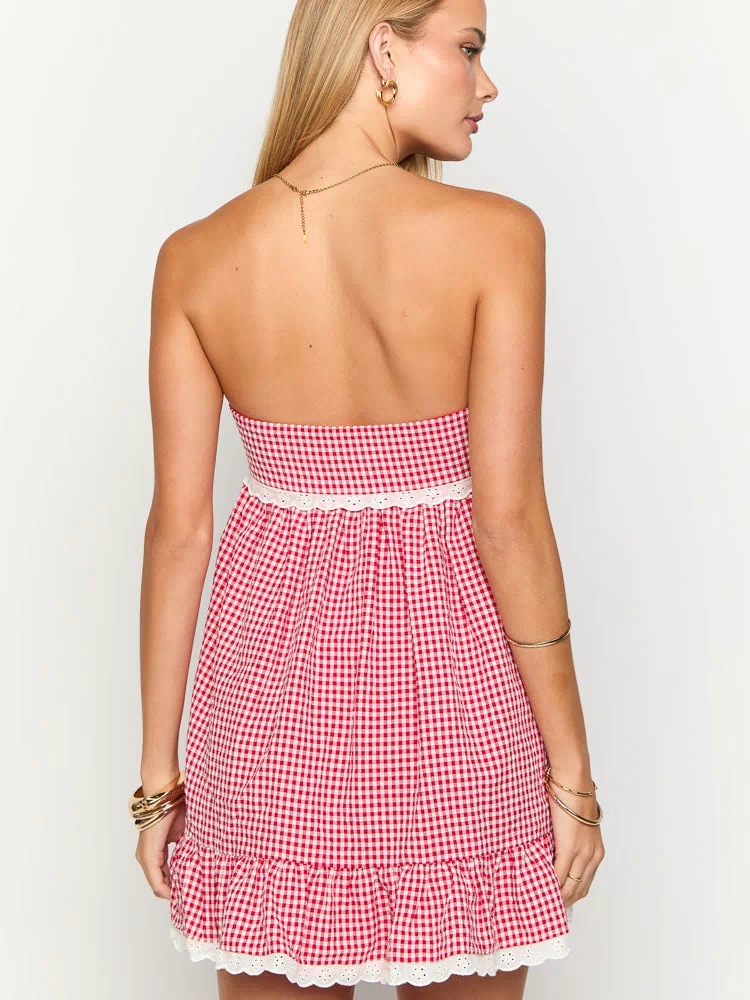 Back view of a red gingham strapless mini dress showing white lace trim at the waist and a ruffled hem with white broderie anglaise