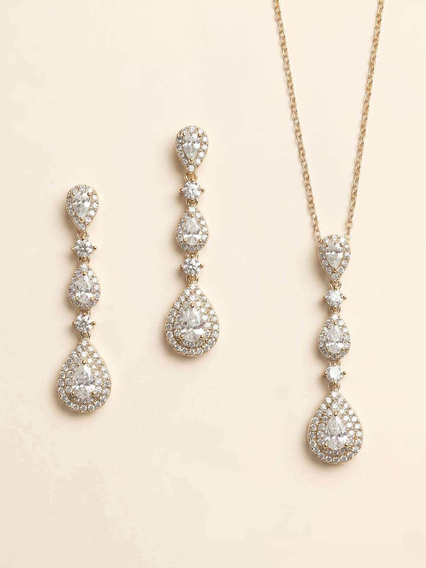a set of elegant jewelry pieces, including earrings and a necklace, both adorned with numerous sparkling diamonds.