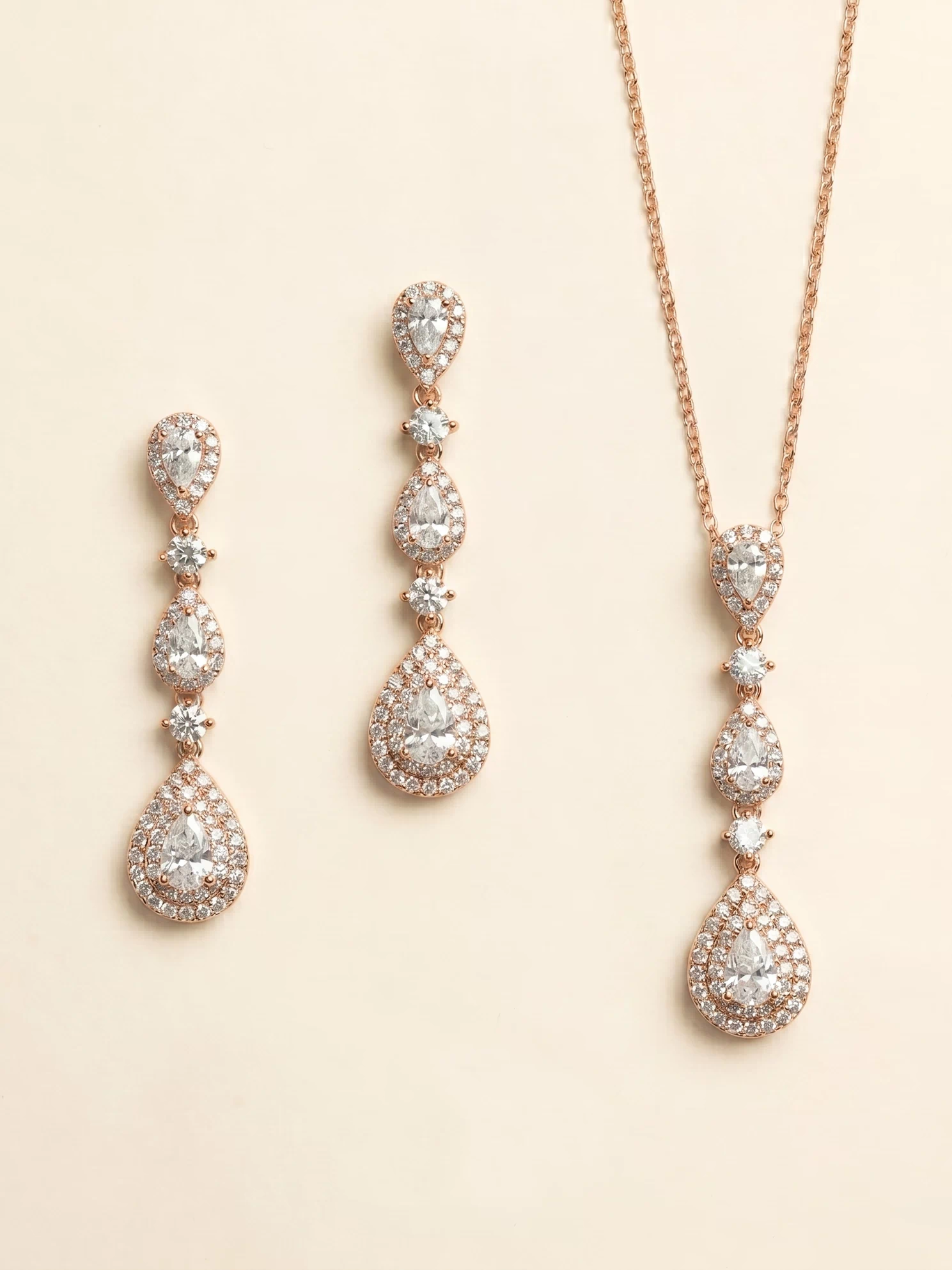 a set of elegant jewelry pieces, including a necklace and earrings, both adorned with numerous sparkling diamonds.