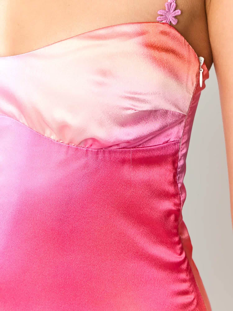 Close-up of the pink ombre satin mini dress bodice, showing the sweetheart neckline, floral lace straps, and side zipper