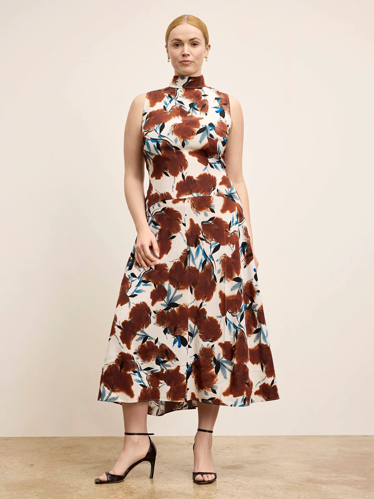 Woman wearing a floral dress with a neutral background