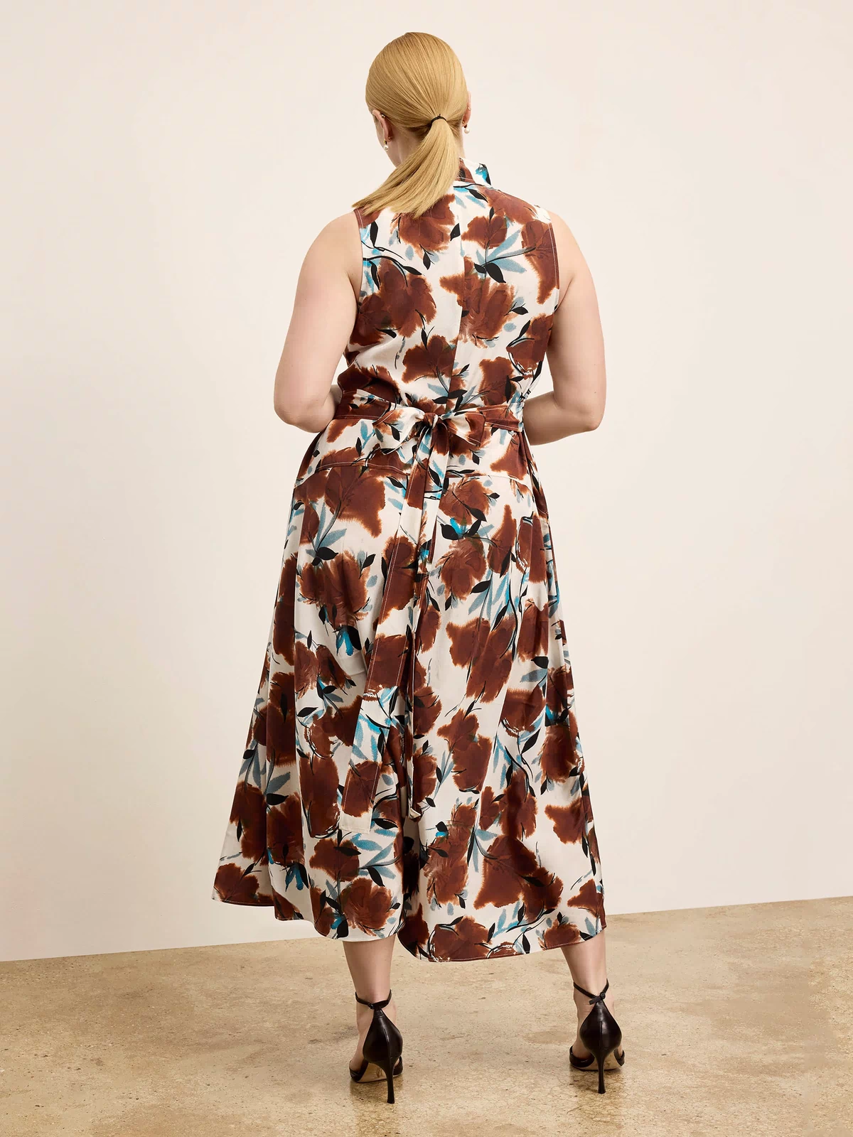 Woman wearing a floral dress with a plain background