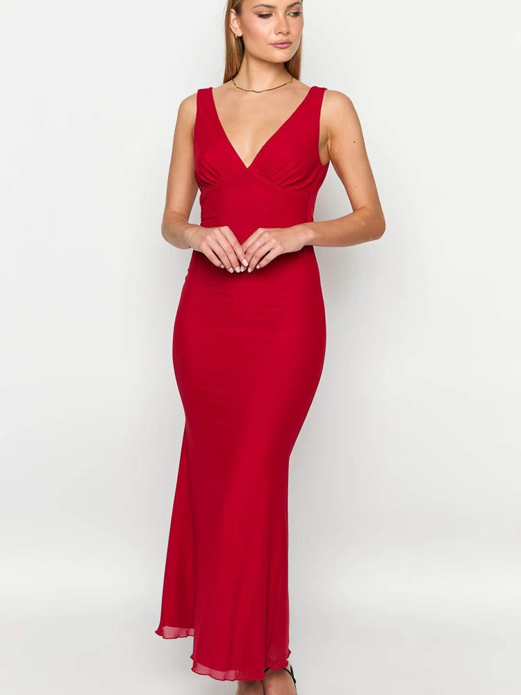 Red sleeveless maxi dress with a deep V-neckline, gathered bodice, and sheer hem