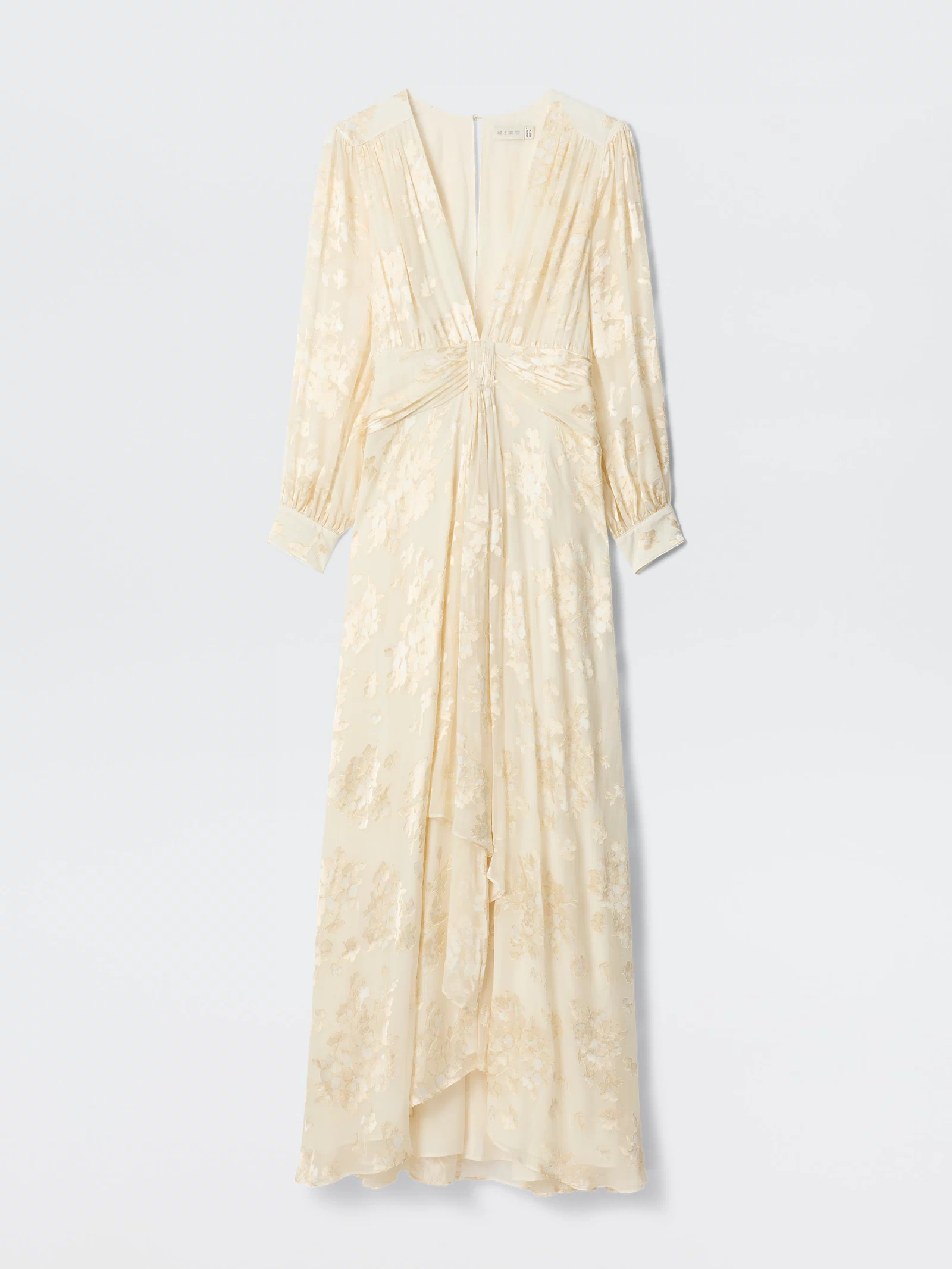 The Meera - Bouquet Devoré Cream is a long cream silk-satin gown with a subtle floral pattern, long sleeves, V-neckline, gathered waist, and flowing layered skirt, elegantly displayed against a plain white background.