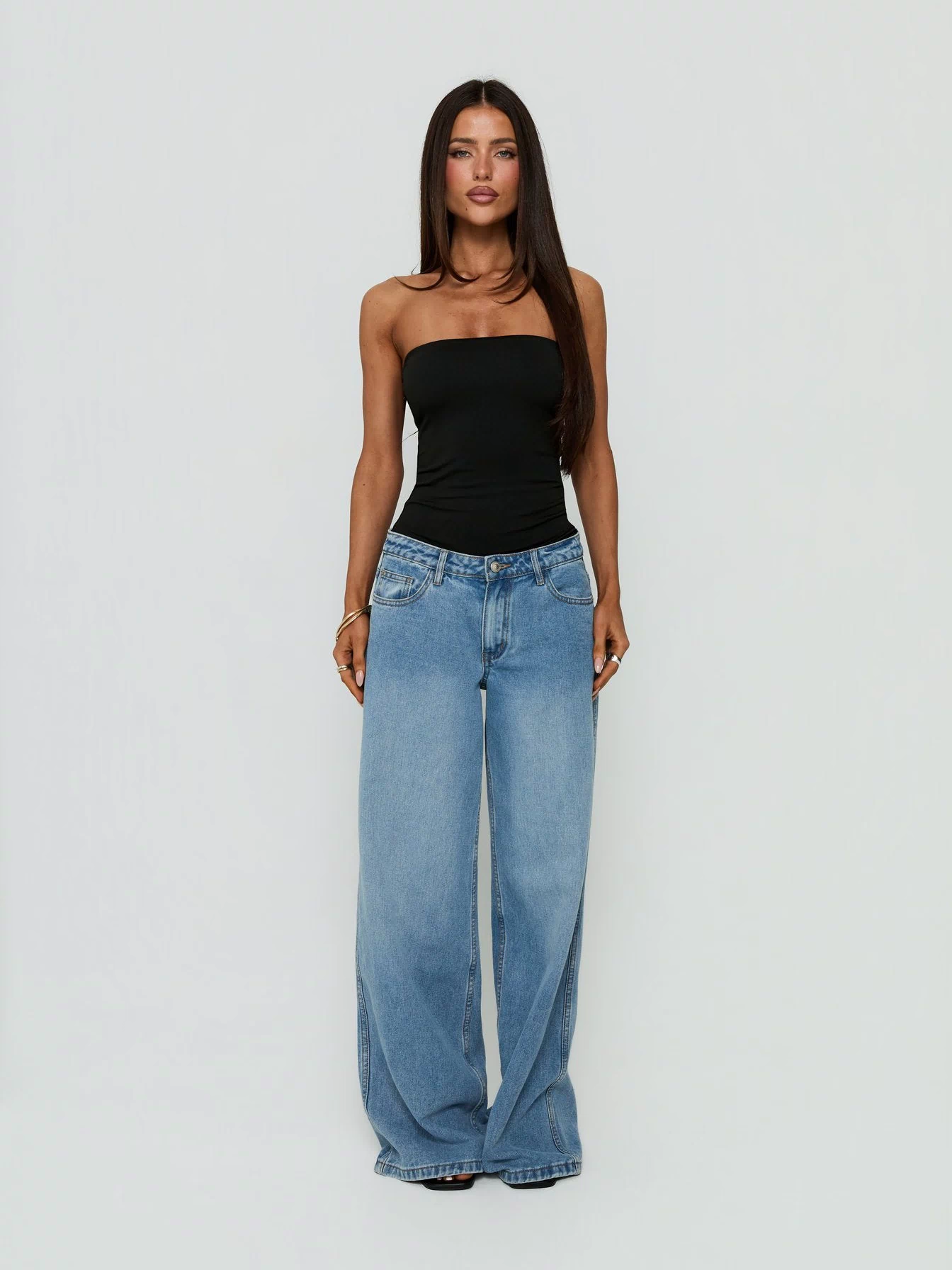 Showcasing the Namari Strapless Bodysuit Black womens-bodysuit with sleeveless and ruched details front view of model wearing Princess Polly