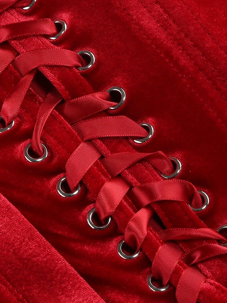 Red velvet corset with silver rings on a red background