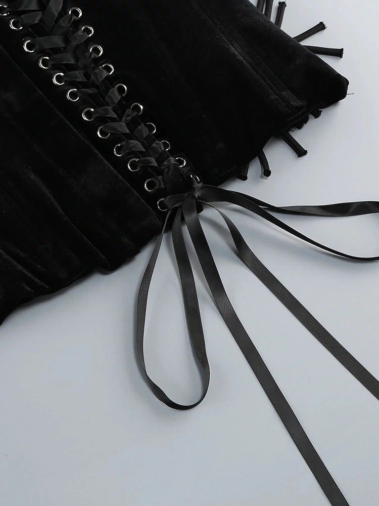 Black velvet corset with ribbons on a white background