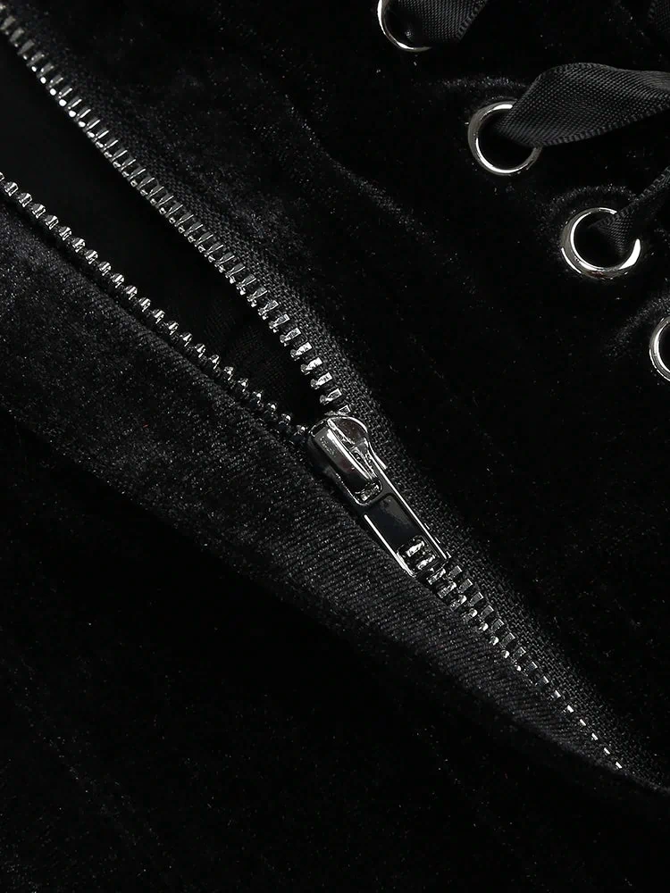Close-up of a black zipper on a black background