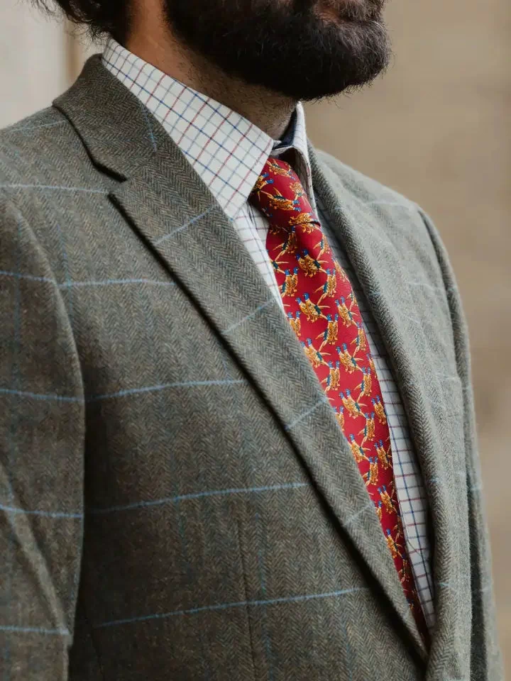 Man in a stylish wool tweed blazer with a red tie, perfect for Forest clothing