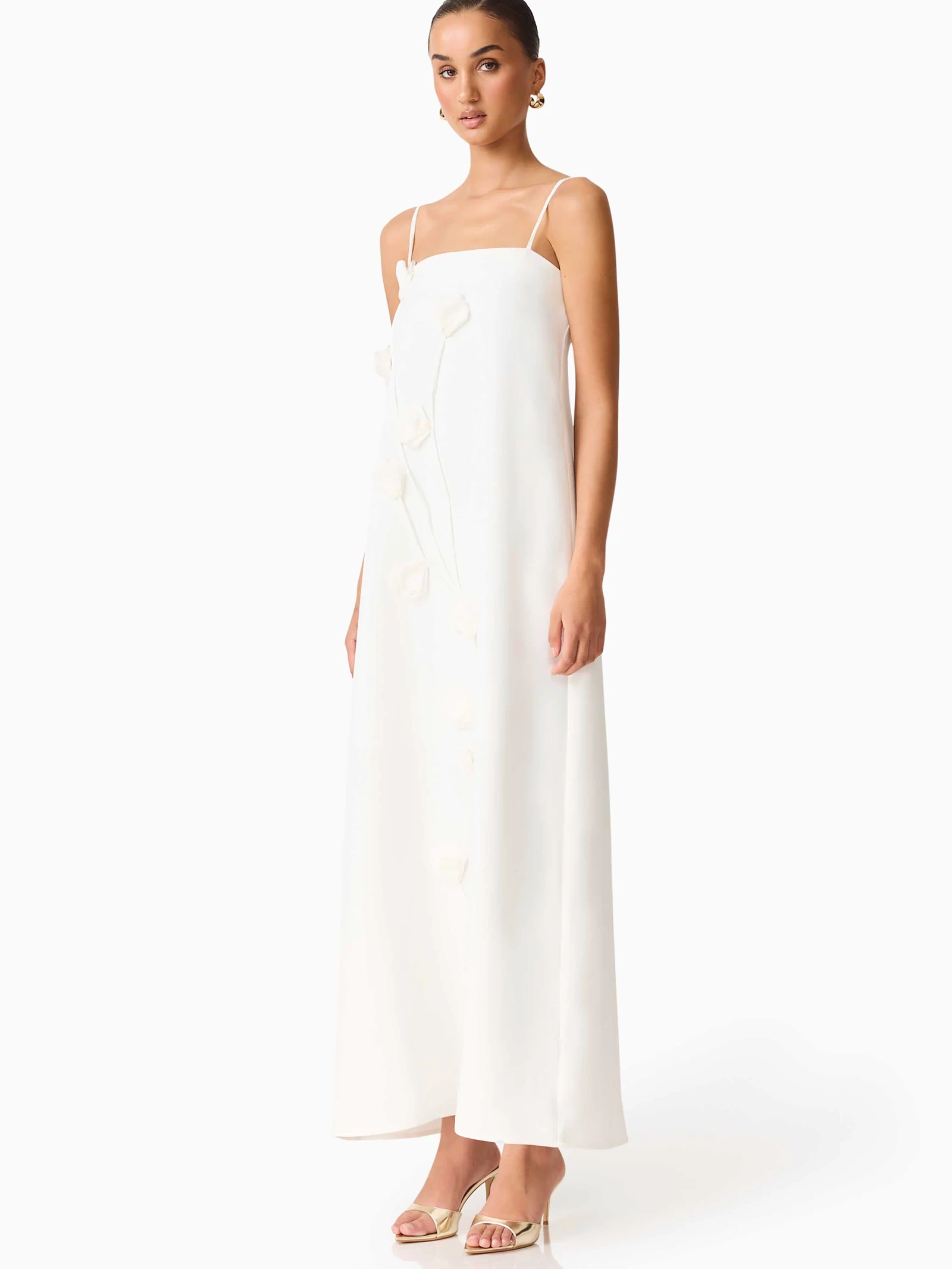 Brunette model wearing Nolana Floral Applique Gown in White side shot