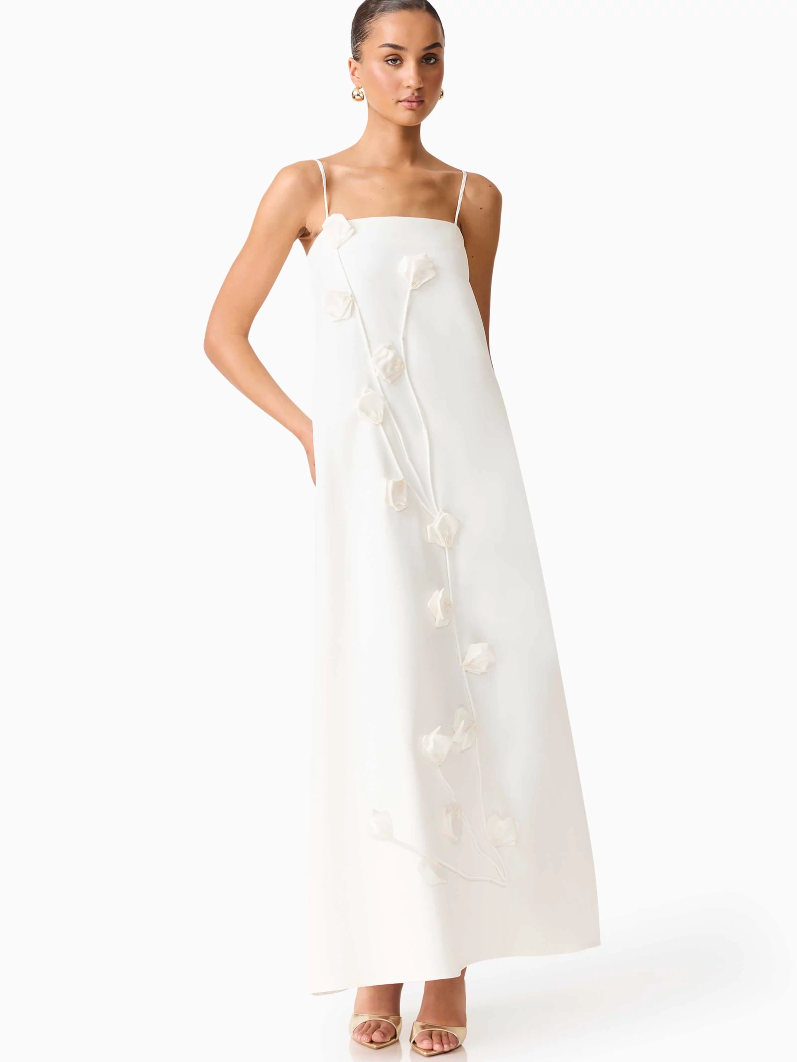 Brunette model wearing Nolana Floral Applique Gown in White posed shot