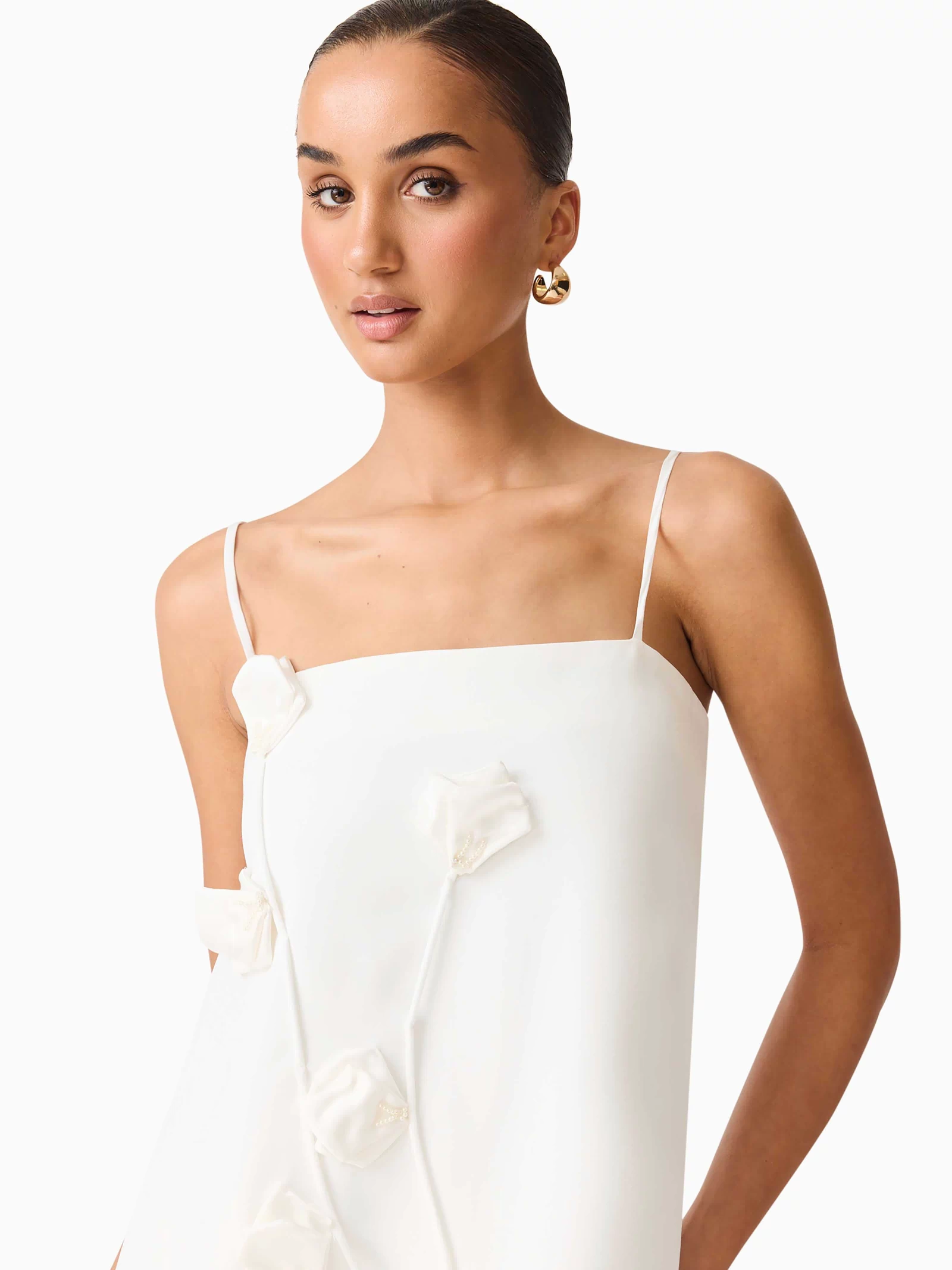 Brunette model wearing Nolana Floral Applique Gown in White detail shot