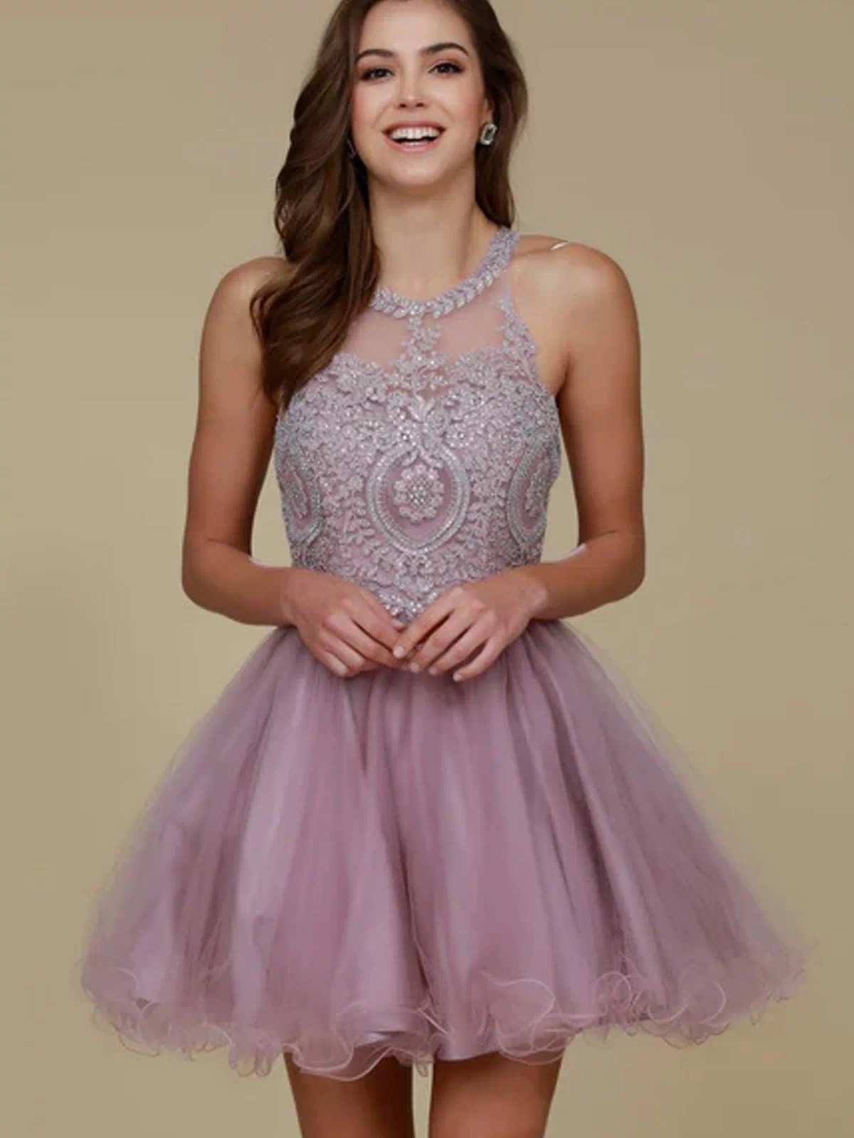 A woman smiles at the camera, wearing the Short Babydoll Homecoming Dress with Beading—sleeveless, lilac, a-line style featuring intricate beadwork on the bodice—standing against a plain beige background.