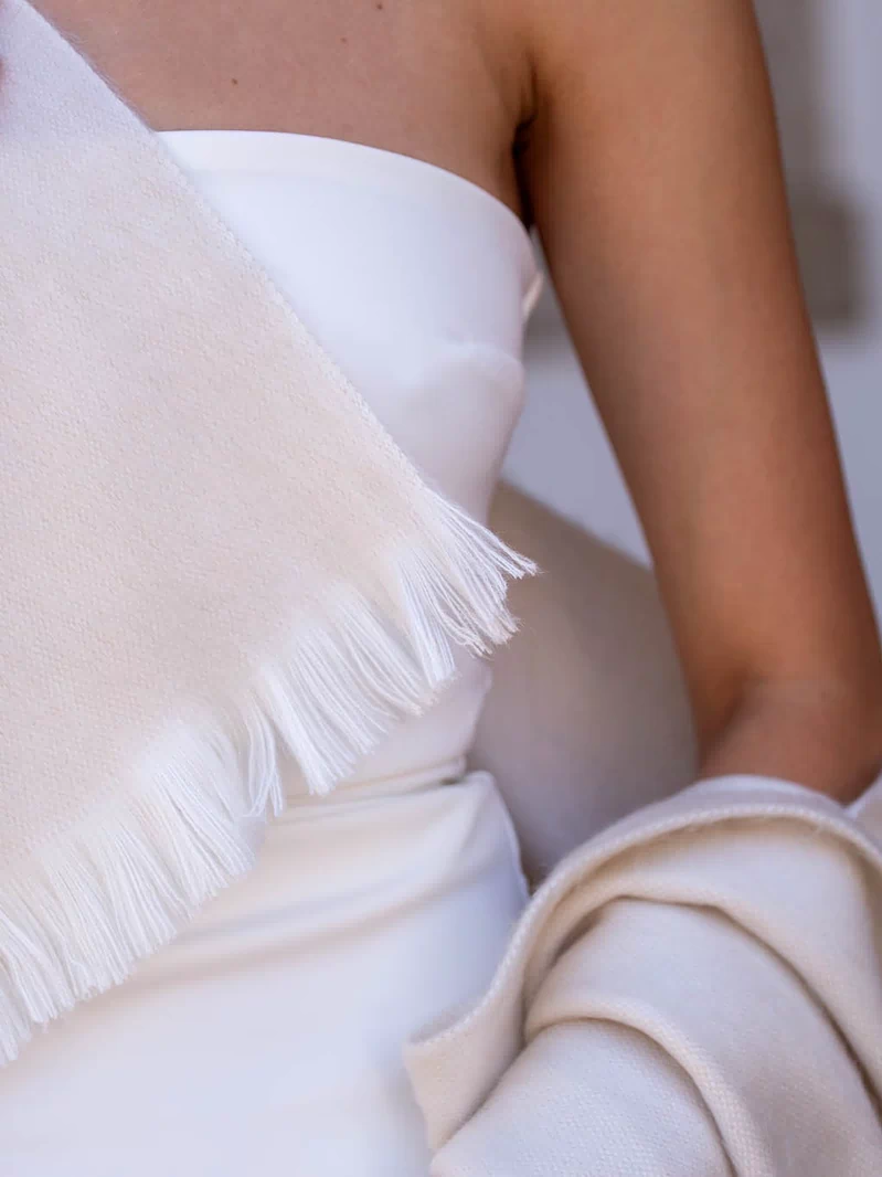 Bride wearing pearl wedding shawl with vintage-style gown