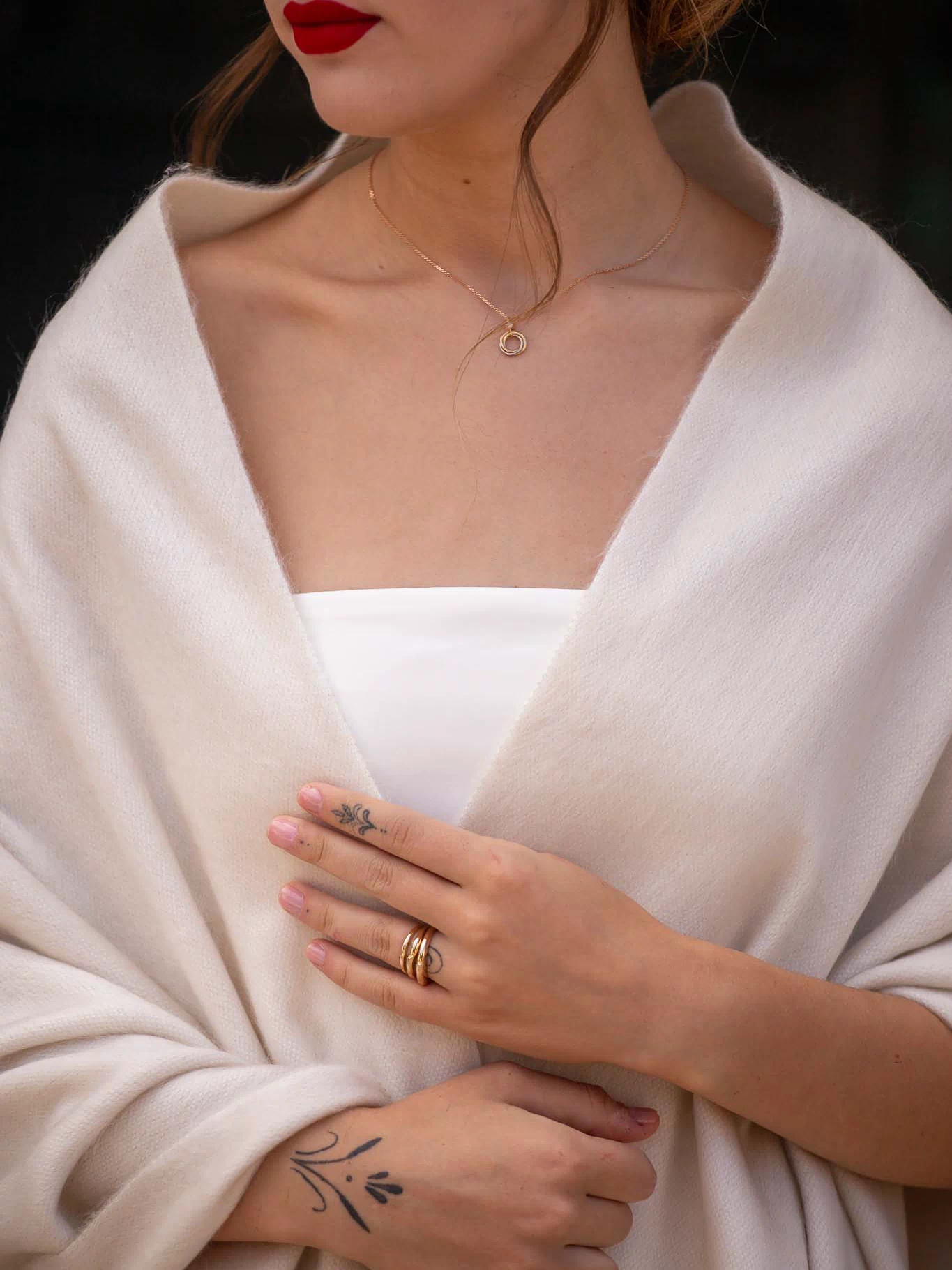 Side view of bride in pearl shawl at candlelit reception