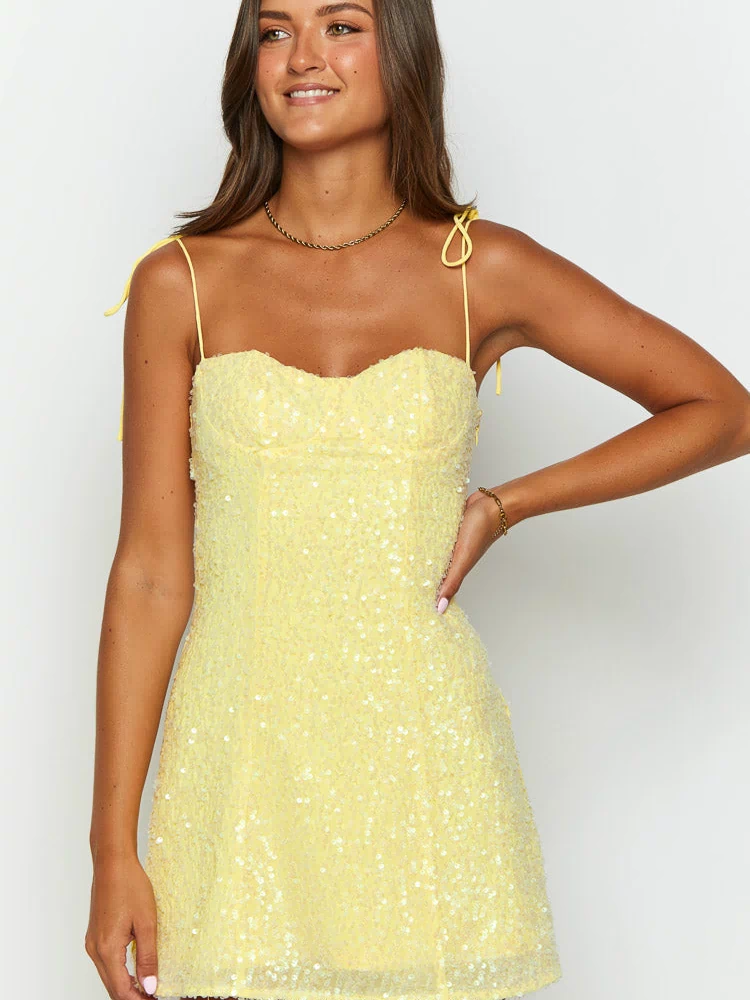 Front view of a yellow sequin mini dress with a sweetheart neckline and tie-up spaghetti straps