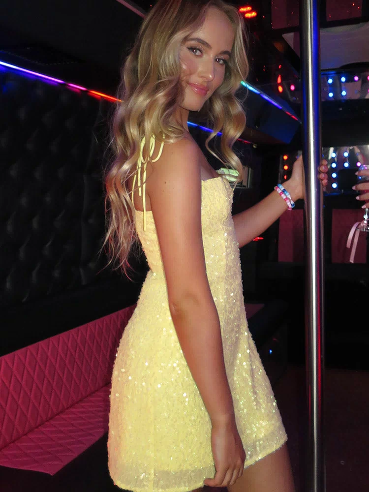 Side view of a yellow sequin mini dress with tie-up spaghetti straps and an A-line fit