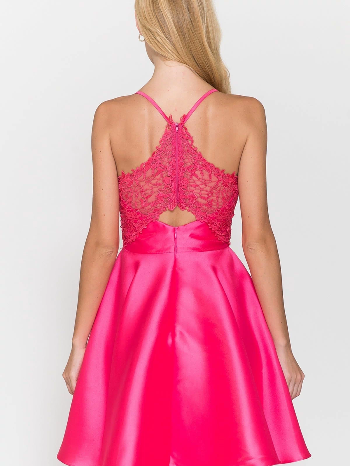 A woman models the Lace-Back Short A-Line Homecoming Dress 8698 in bright pink, featuring a flared satin skirt and lace back, shown from behind against a plain background.