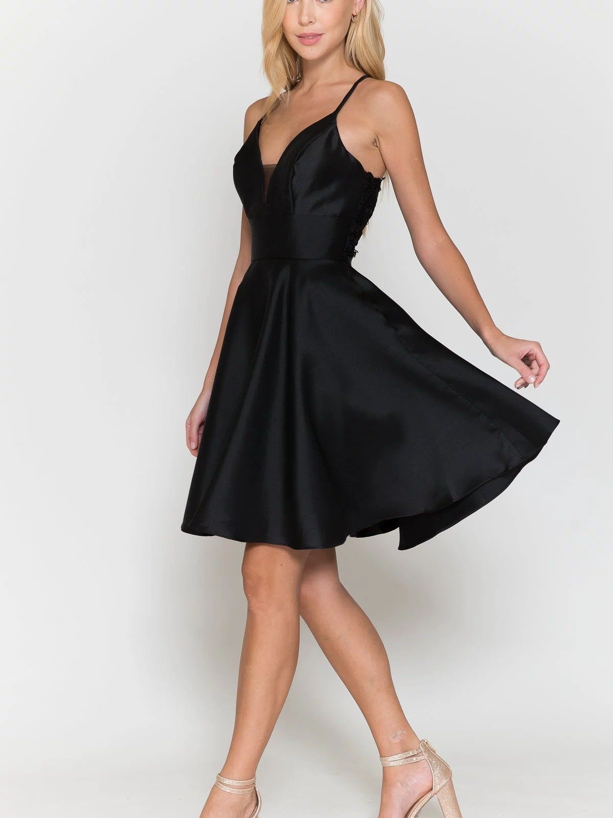 A woman models the Lace-Back Short A-Line Homecoming Dress 8698 with heeled sandals against a plain white background.