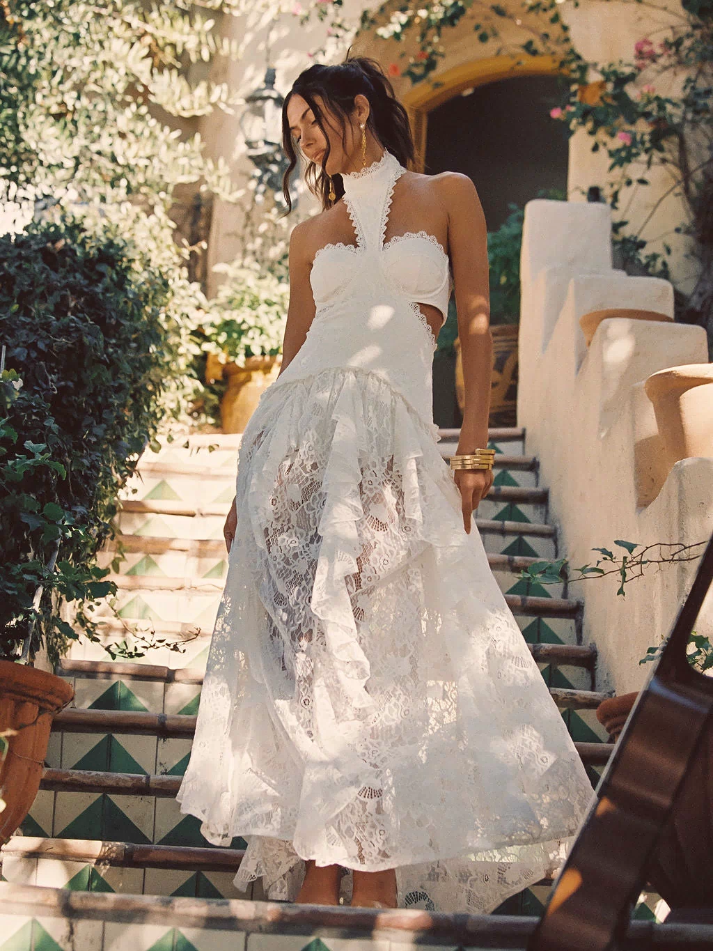 Full-length view of the white maxi dress showing the drape and movement.