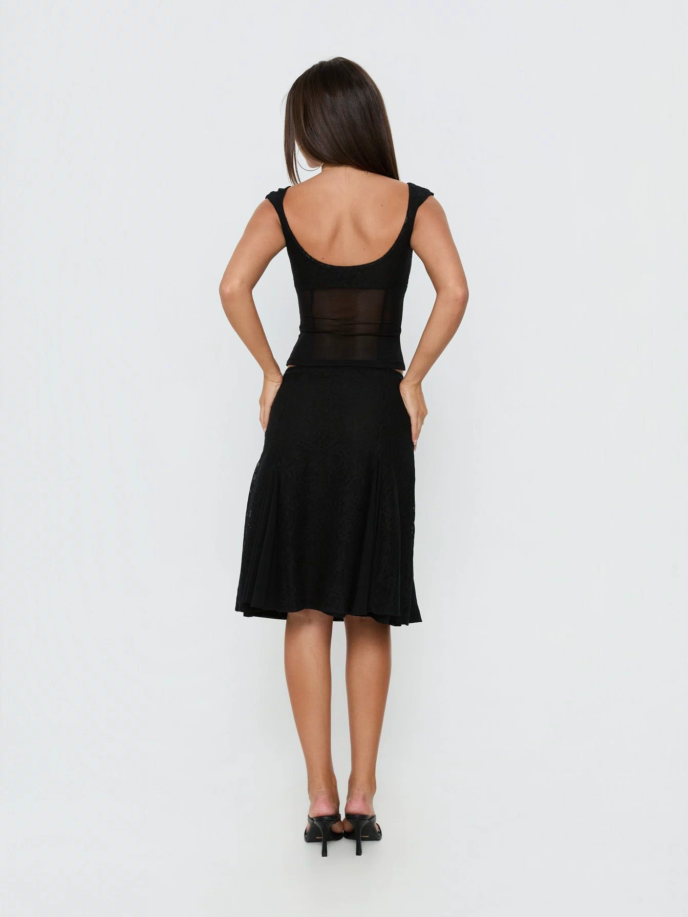 Presenting the Quani Lace Midi Skirt Black womens-skirts with fitted aline silhouette and midi length back view of model wearing Princess Polly