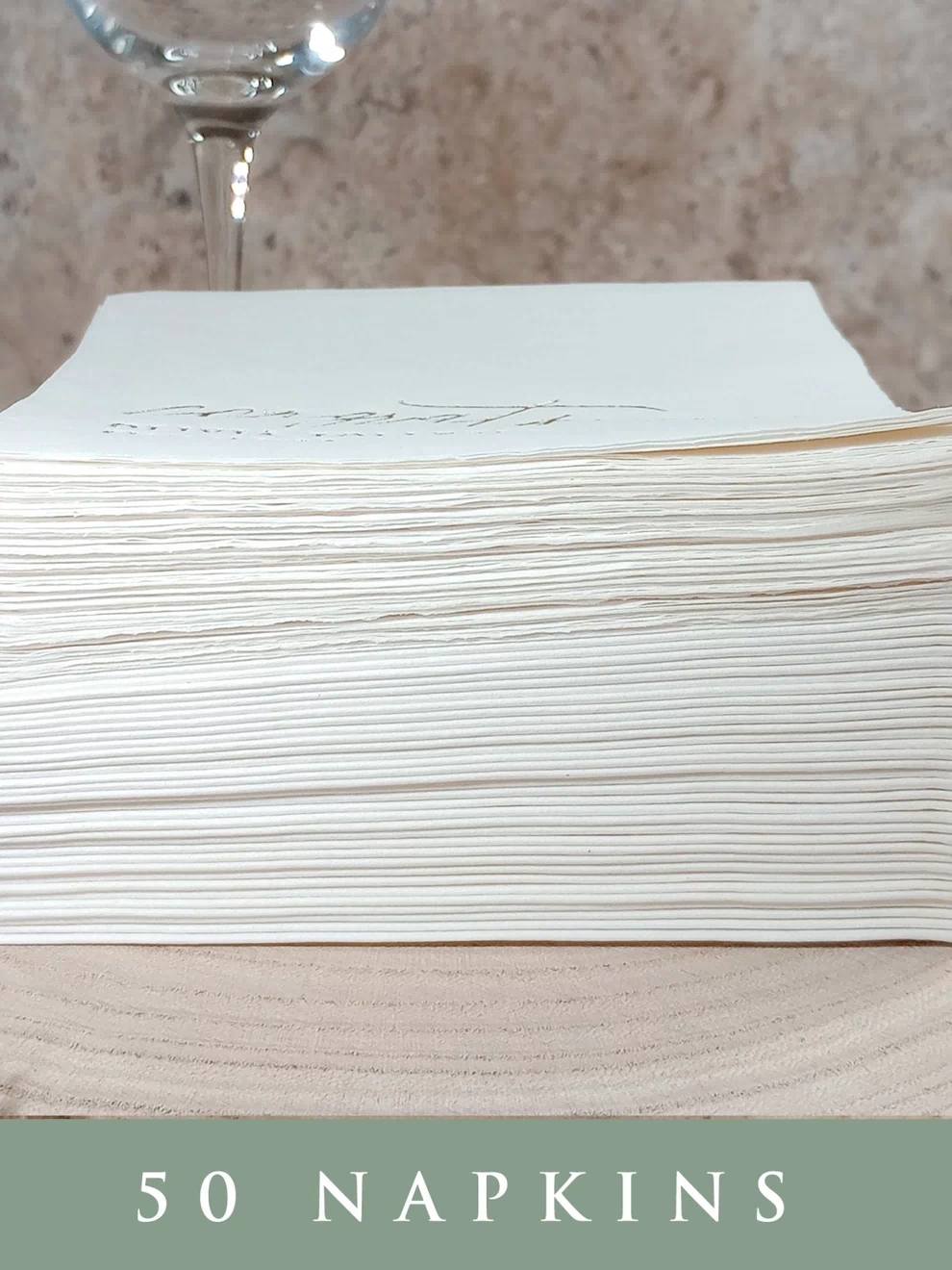 Set of 50 custom wedding napkins stacked neatly, showcasing premium 3-ply thickness.
