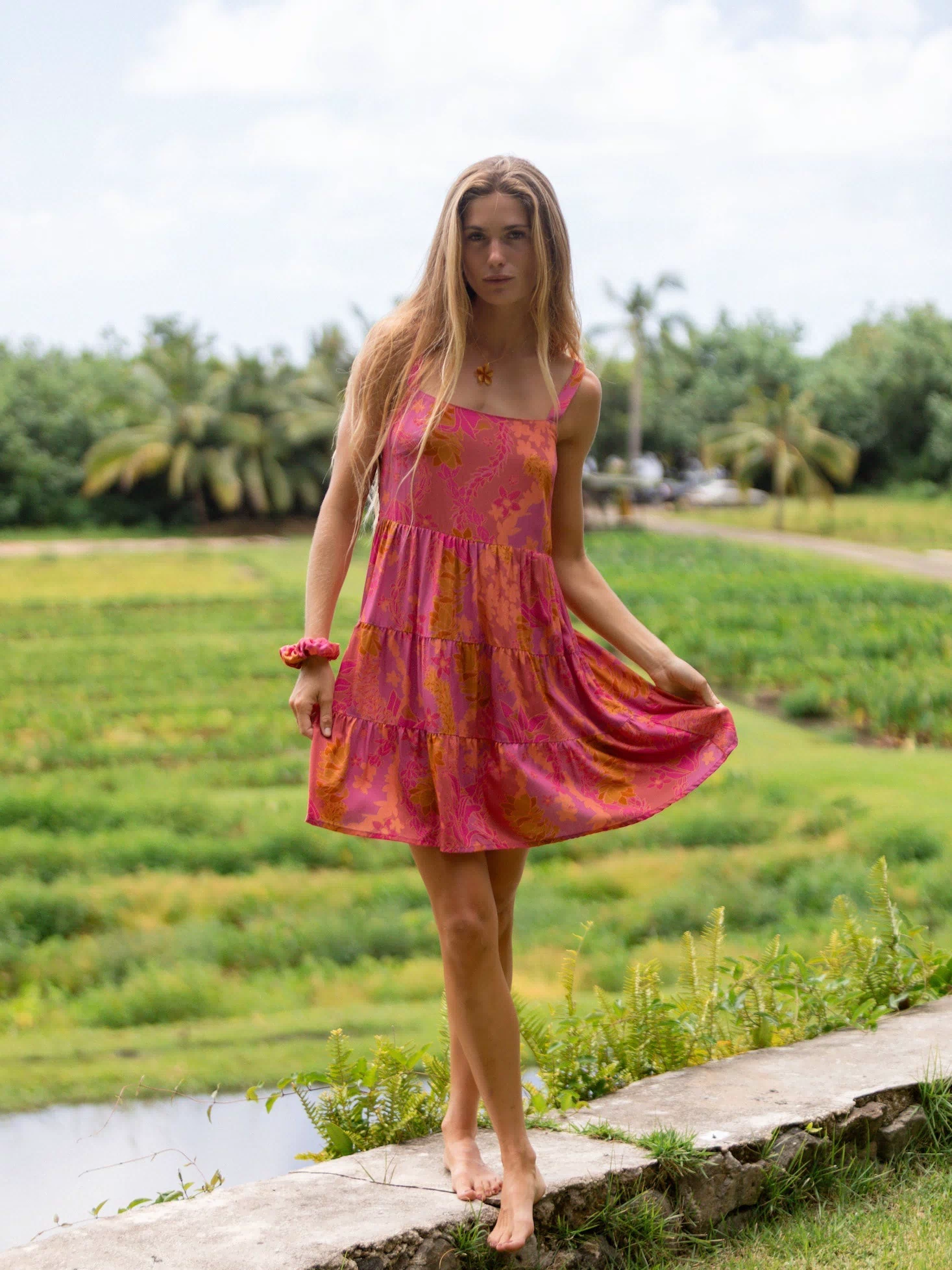 woman wearing a pink mini dress with lei print
