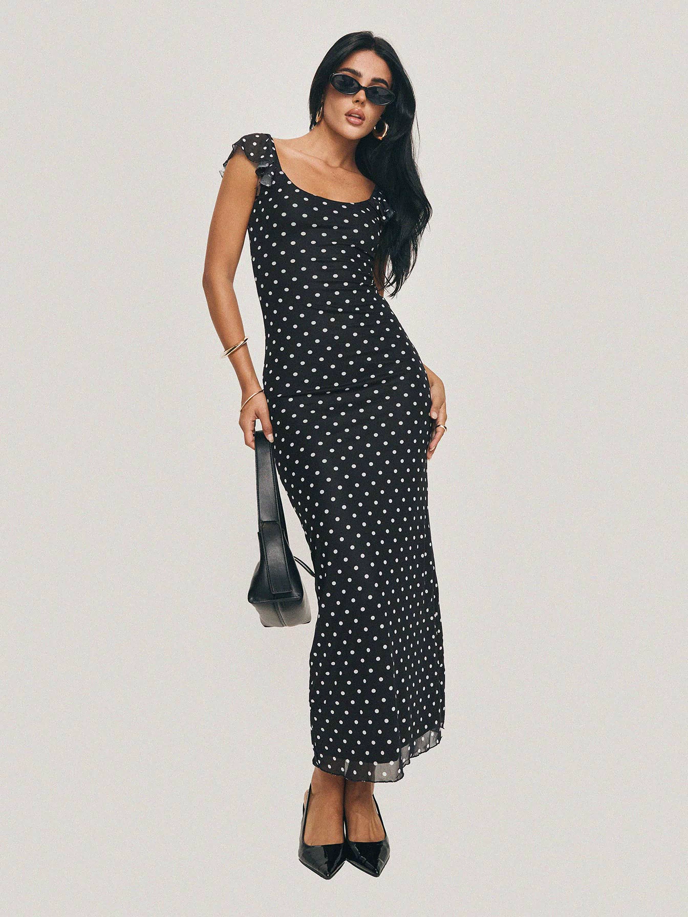 side view of model wearing Princess Polly Sandberg Maxi Dress Black Polka Dot Scoop Neck 