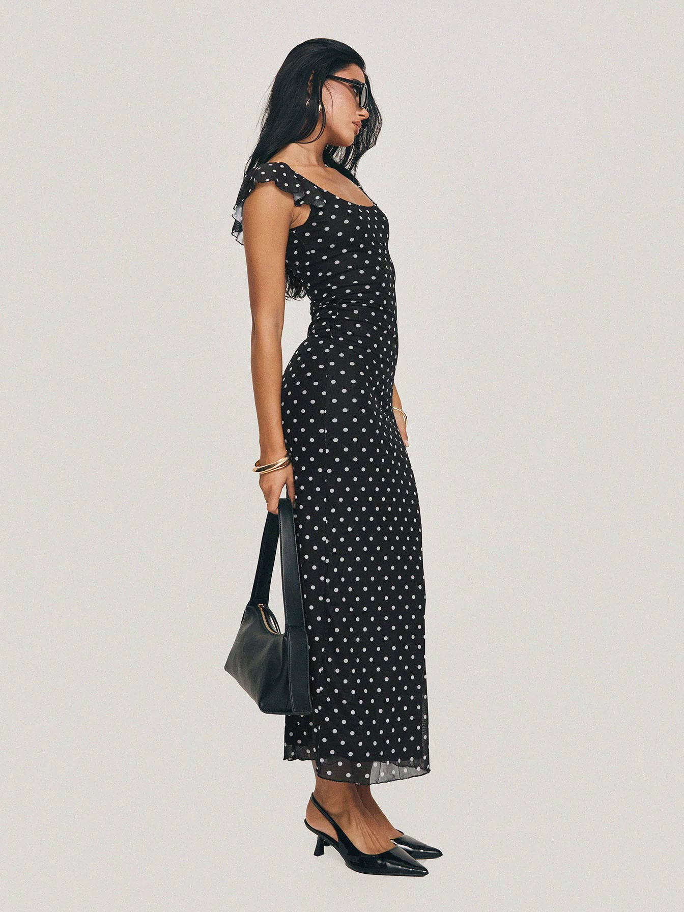 side view of model wearing Princess Polly Sandberg Maxi Dress Black Polka Dot Scoop Neck 