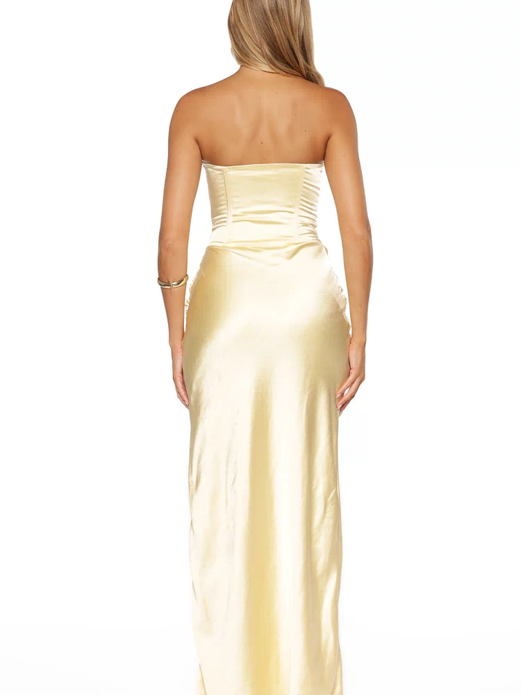 Back view of a yellow strapless satin maxi dress with a structured ruched bodice and subtle gathering on the skirt