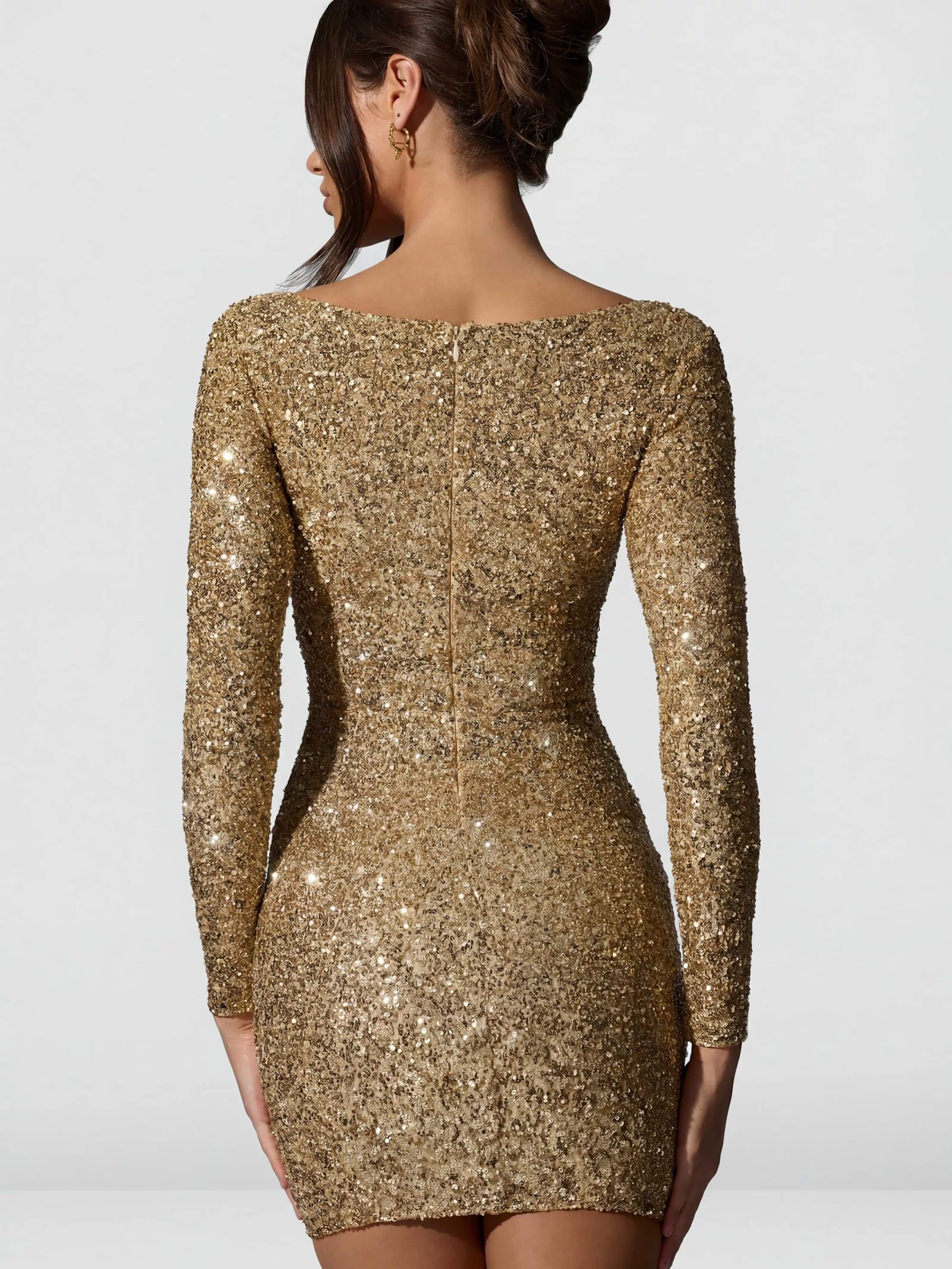 Oh Polly's Anna wearing the Sephina Mini Dress in Gold Micro Sequin fabric perfect for a night out