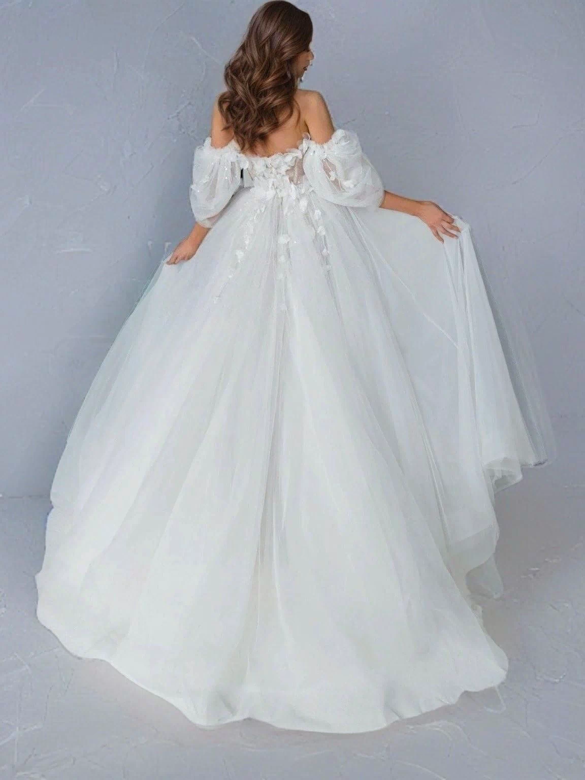Full-length image of the SHERYL gown with its flowing sweep train.