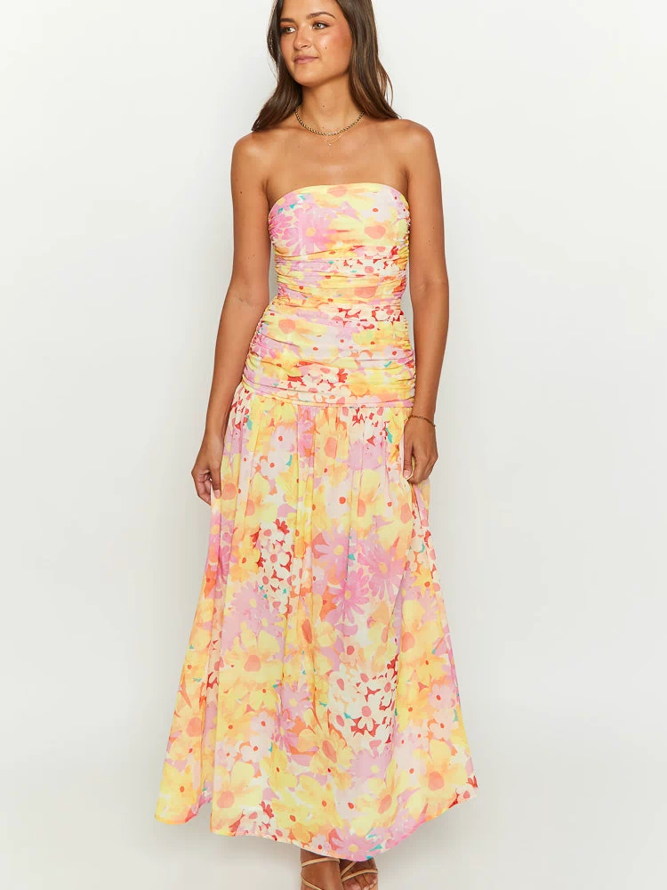 Front view of a yellow floral print strapless maxi dress featuring a ruched, fitted bodice and a flowing skirt