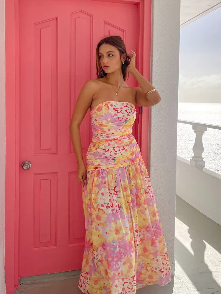 Yellow floral print strapless maxi dress with a ruched bodice and a full, flowing skirt