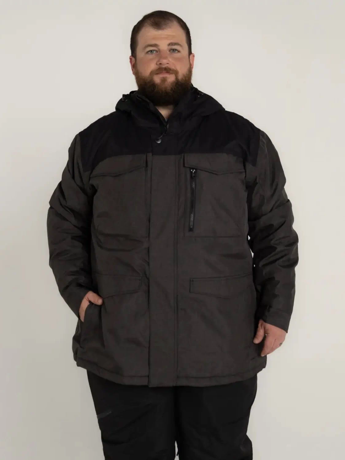 Man wearing a black and gray Snow Country Outerwear insulated winter parka coat