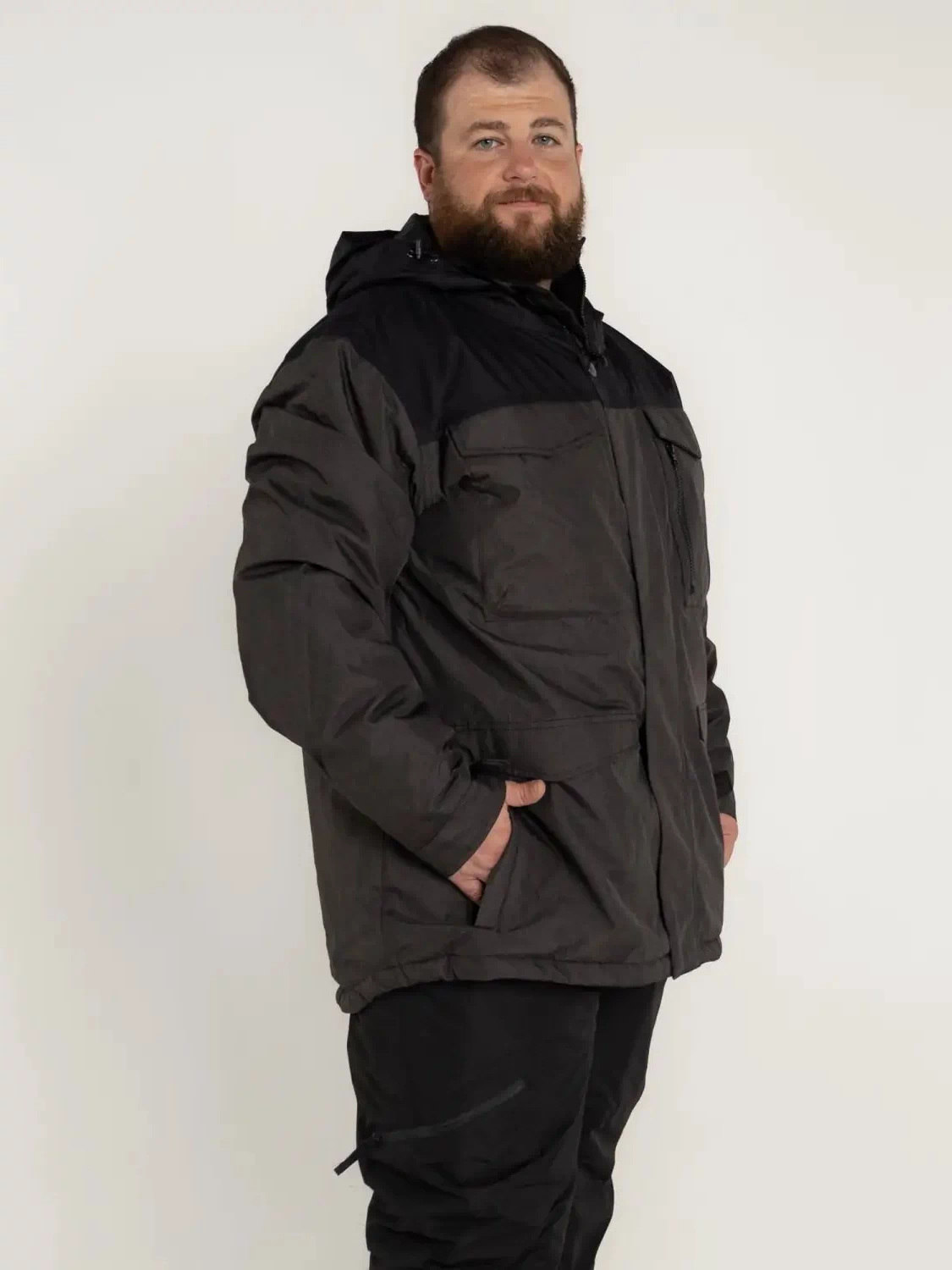 Man in a black and gray insulated winter parka from Snow Country Outerwear for big sizes