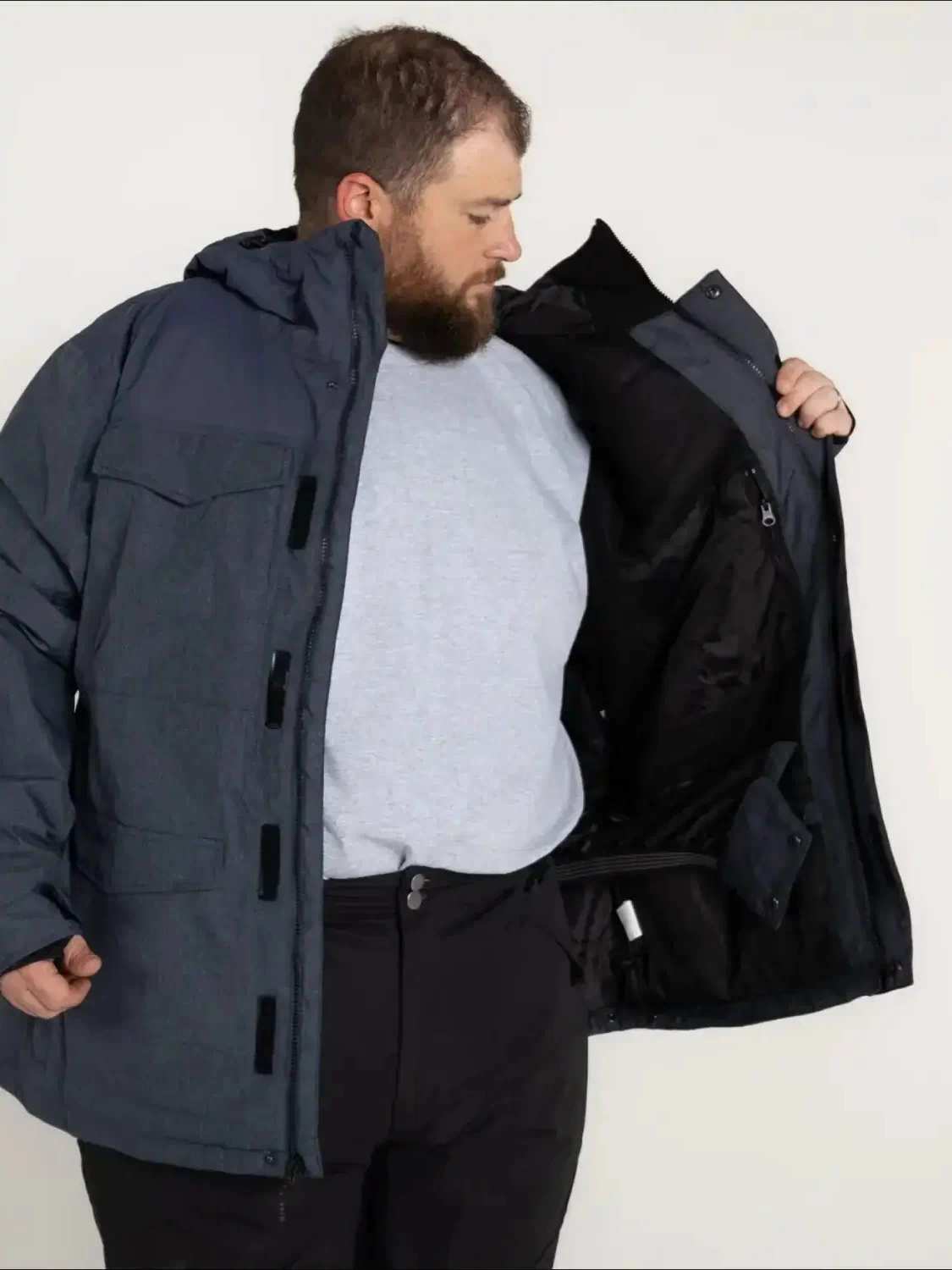 Man in a blue parka jacket from Snow Country Outerwear Men’s winter ski coat collection