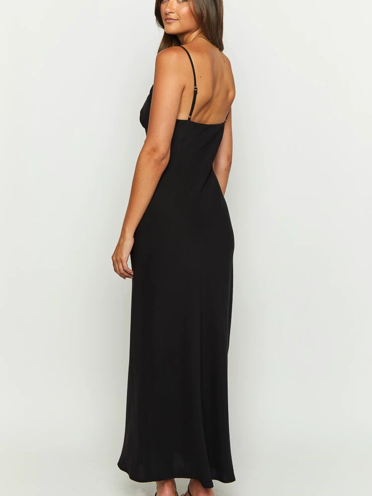 Side view of a black maxi dress with thin adjustable spaghetti straps and a low back