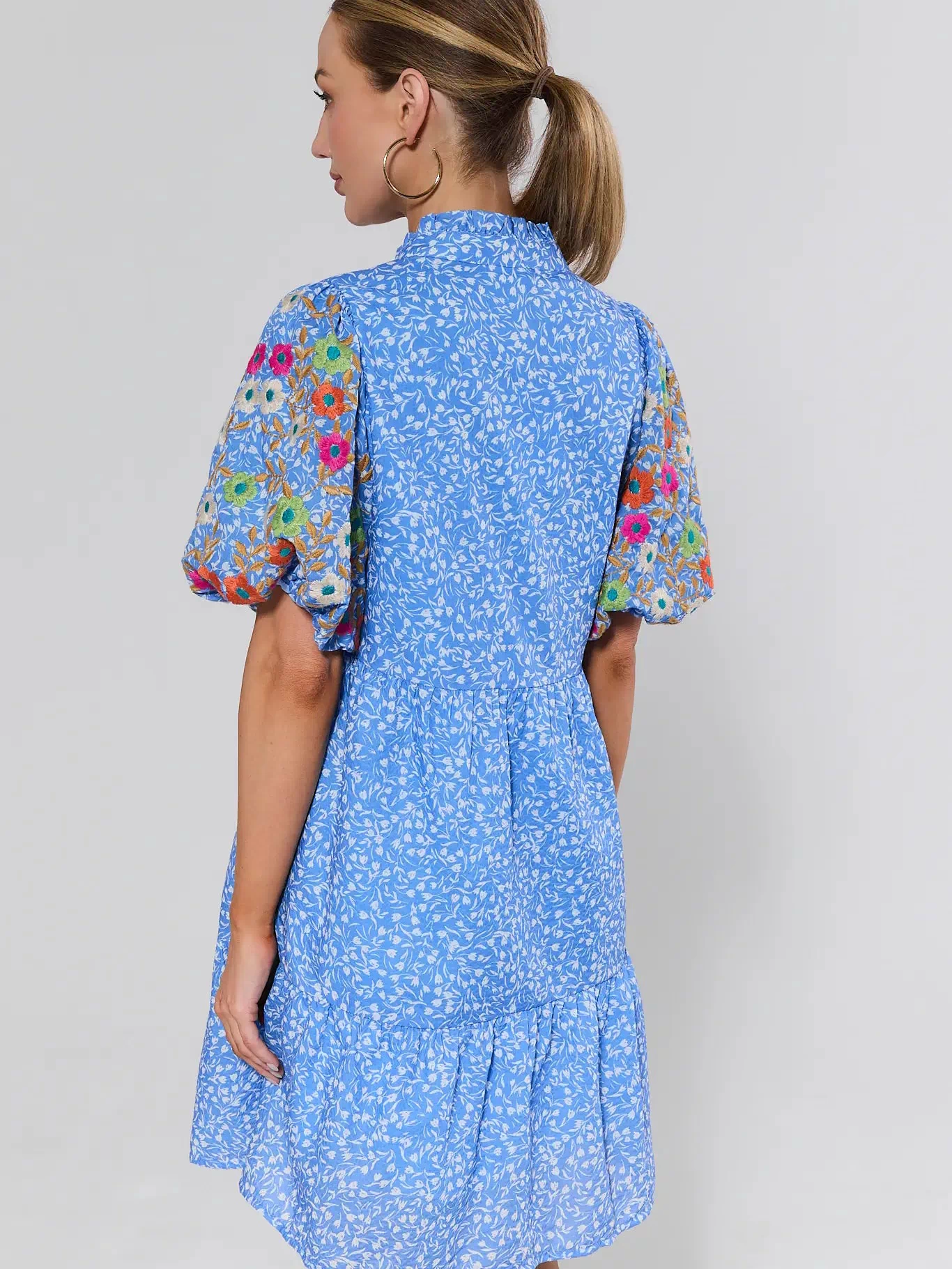 Sue Ann Blue Floral Short Dress by THML - back view showing ditsy floral print, colorful embroidered sleeves, and tiered hem | Avara