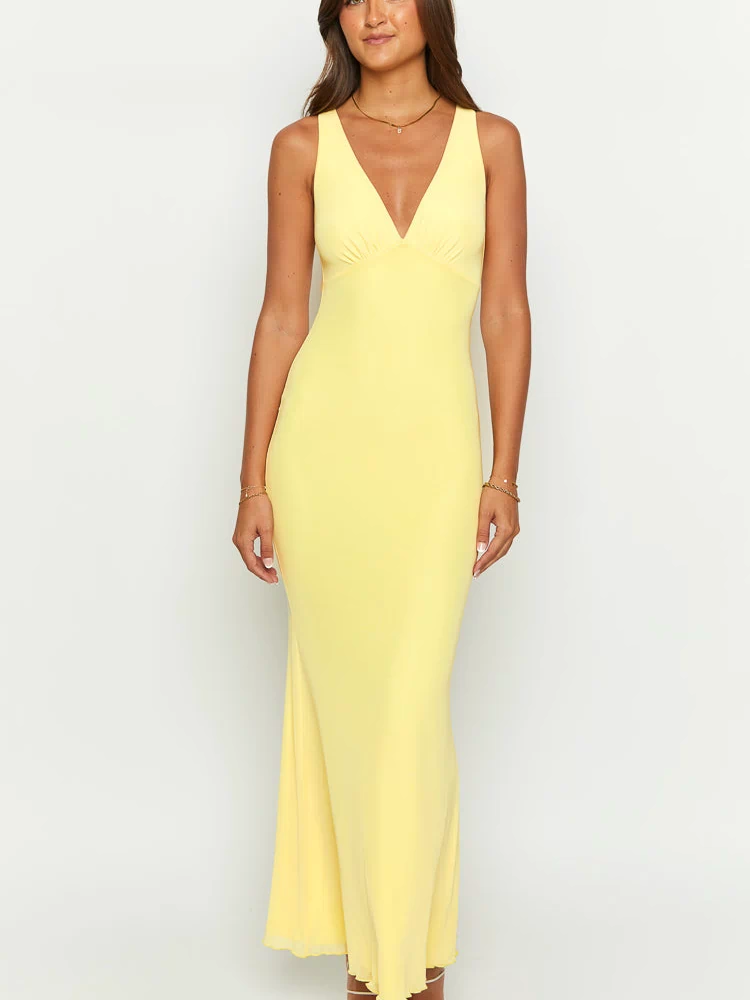 Front view of a sunflower yellow mesh maxi dress with a deep V-neck and ruched bust detail