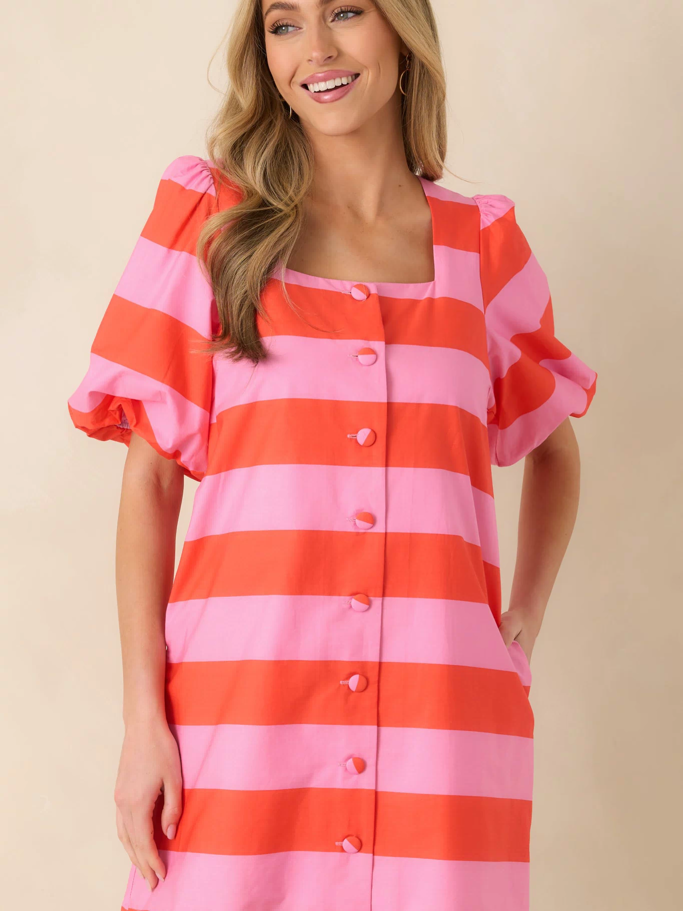 Midsection of the mini dress emphasizing the alignment of the bright stripe design.