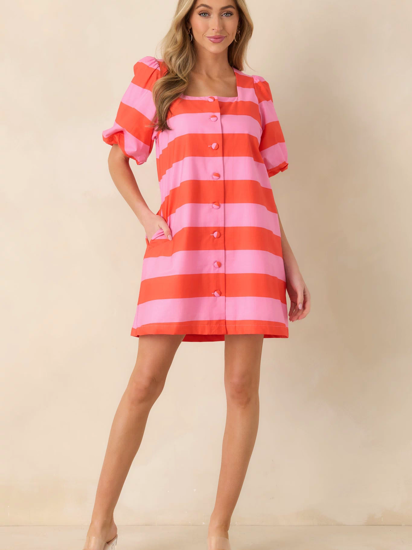 Colorful striped mini dress designed with a lively pattern and effortless shape.