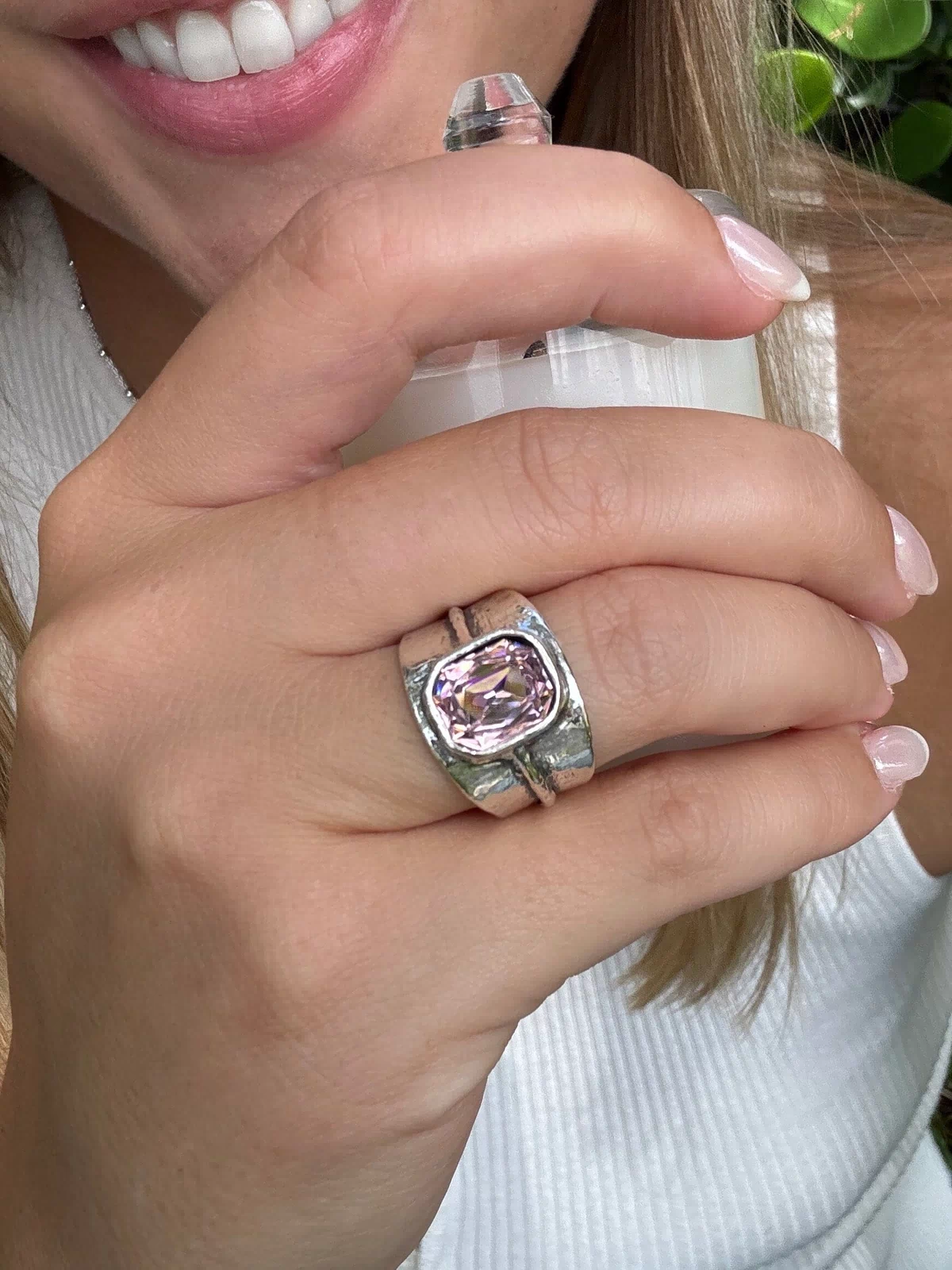wide sterling silver ring with a cushion-cut pink stone