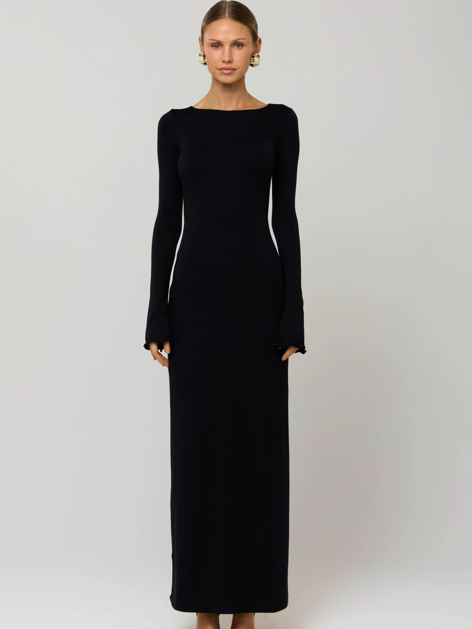 This is an image of Sylvia Dress in Black Knit - RESA featuring a model wearing the dress