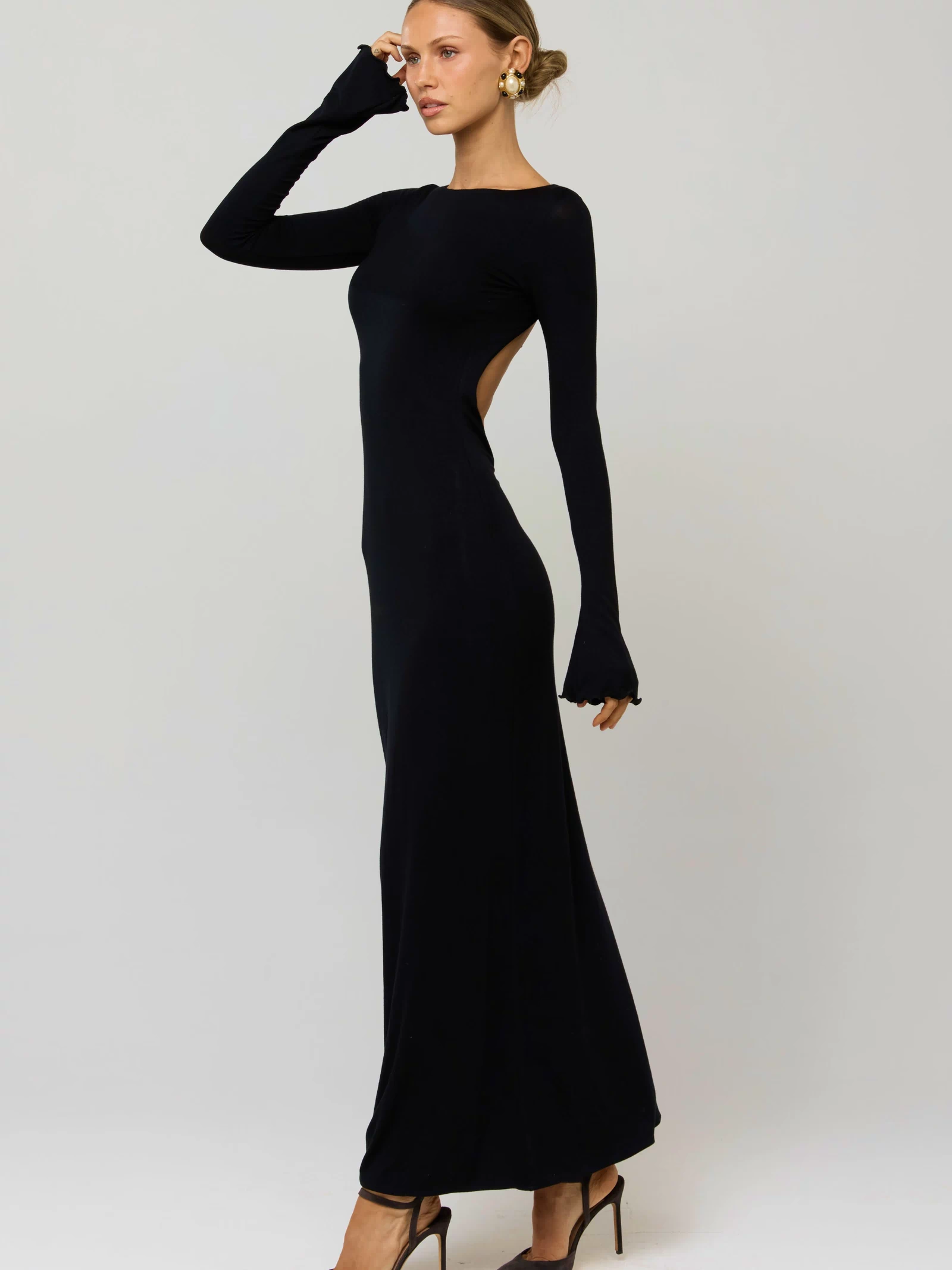 This is an image of Sylvia Dress in Black Knit - RESA featuring a model wearing the dress