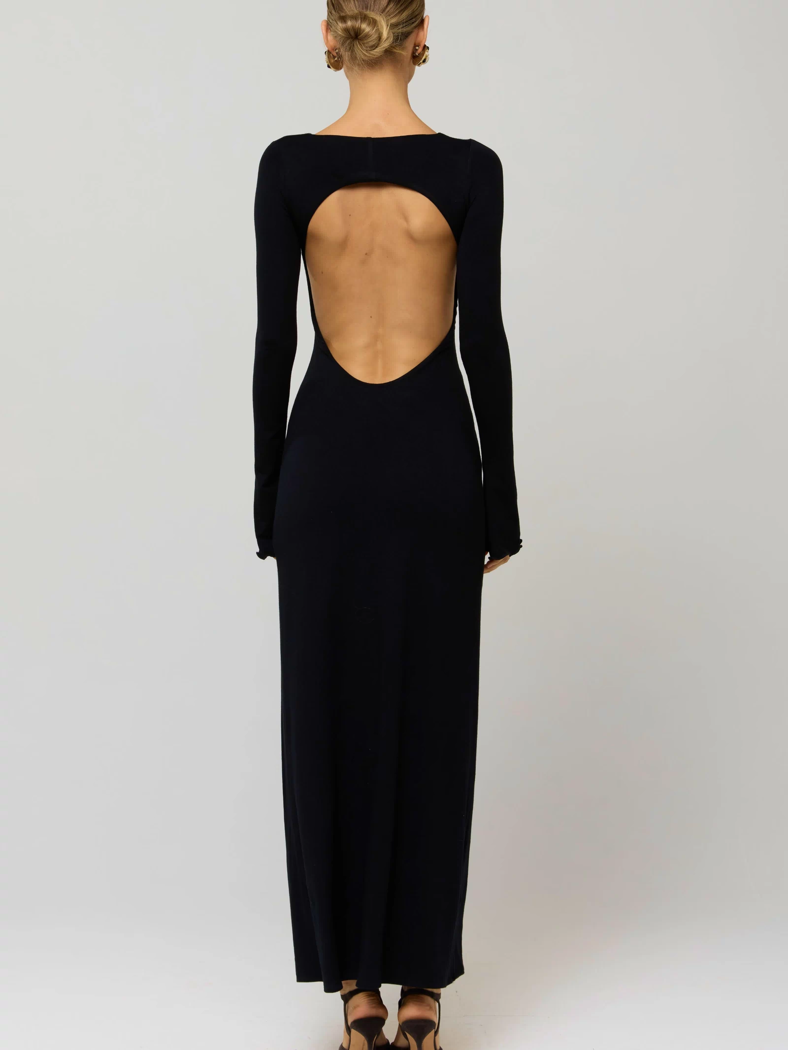 This is an image of Sylvia Dress in Black Knit - RESA featuring a model wearing the dress