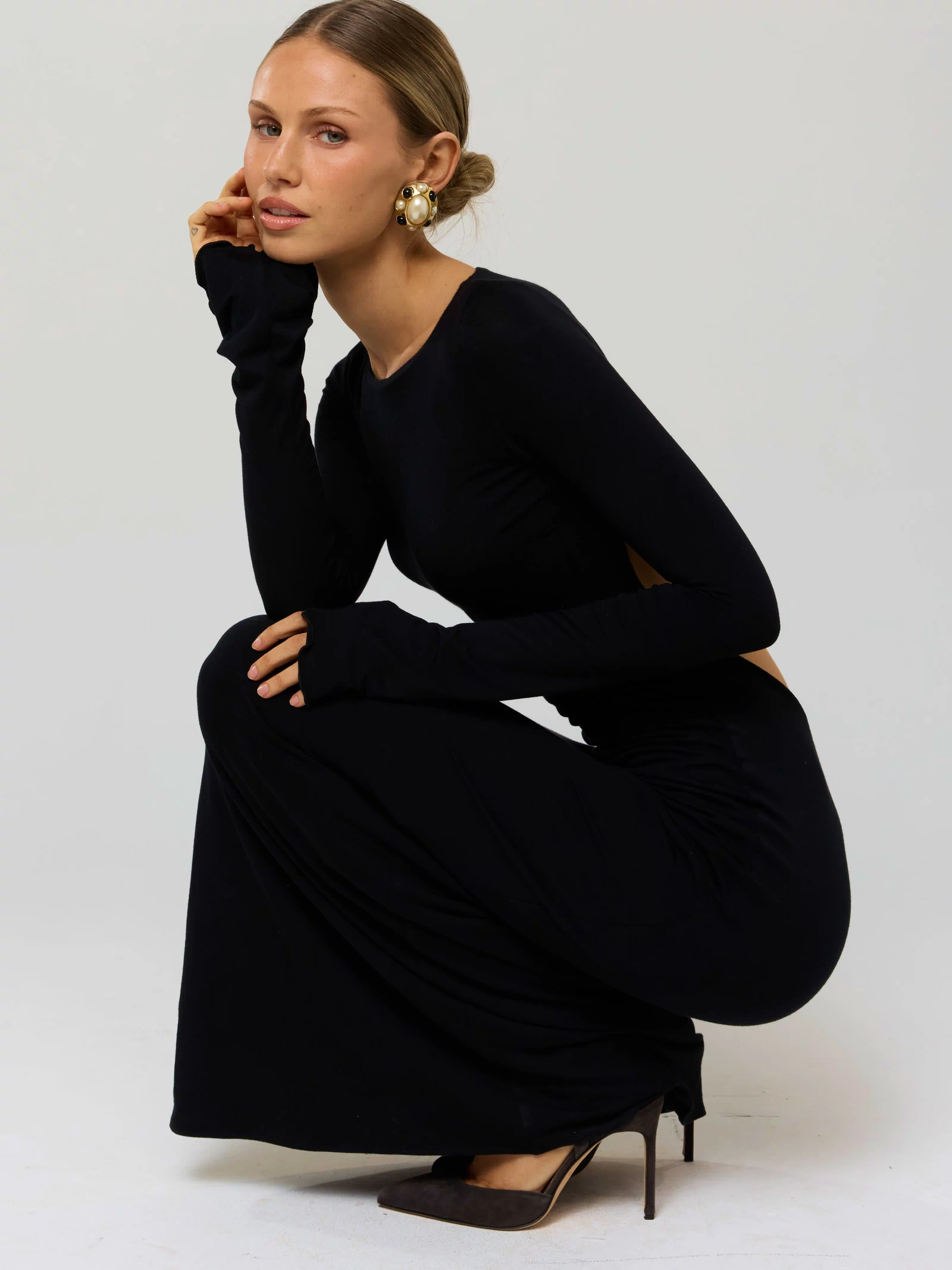 This is an image of Sylvia Dress in Black Knit - RESA featuring a model wearing the dress