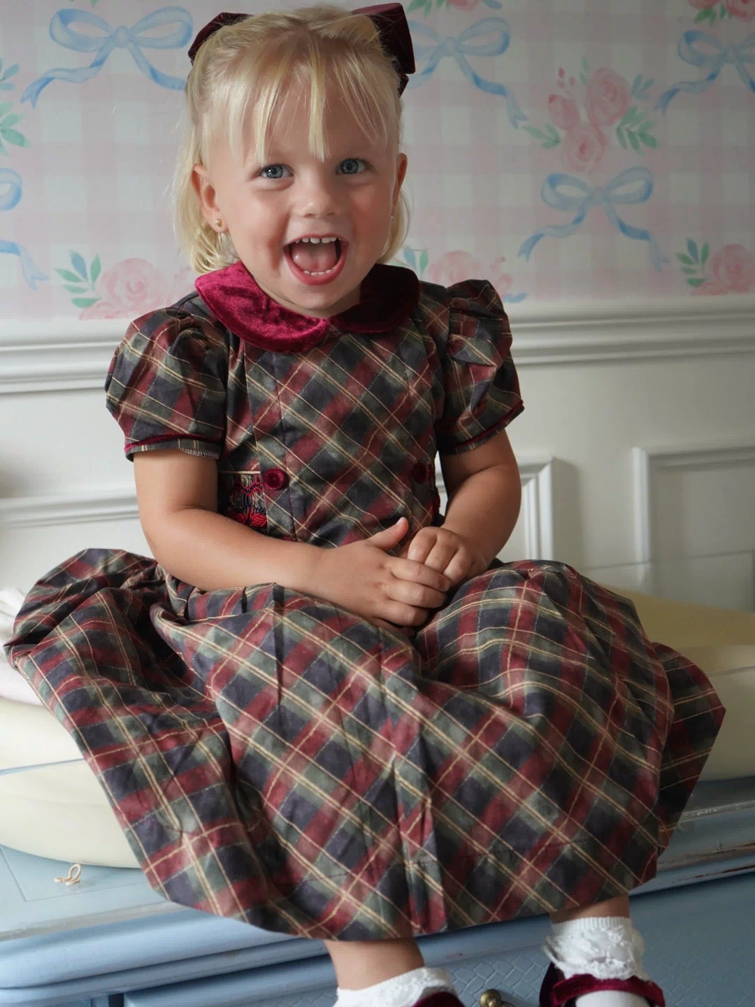 Girl wearing Tartan Luxe Handsmocked Christmas Dress