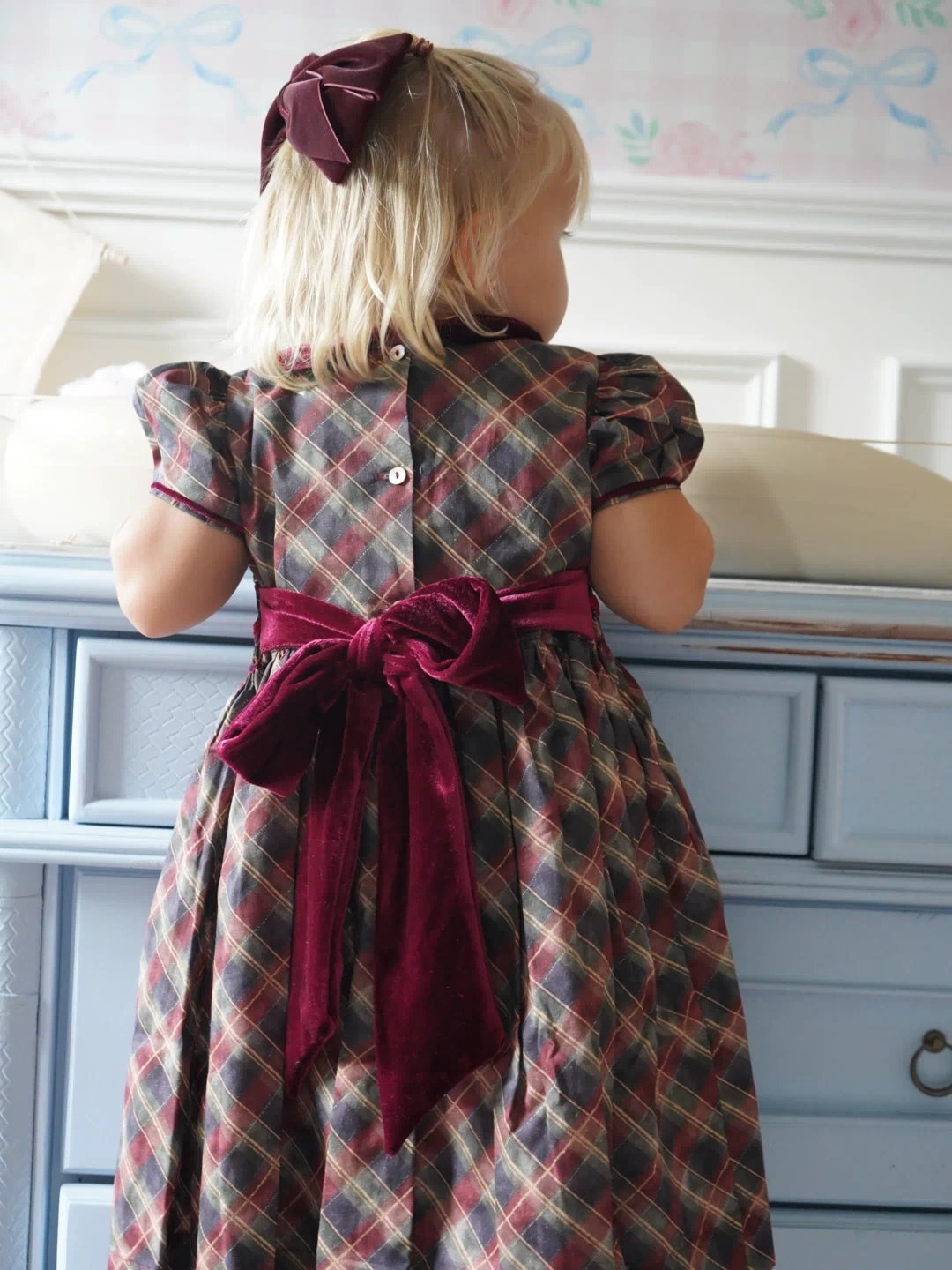 Back view of Tartan Luxe Handsmocked Girl Dress with velvet bow